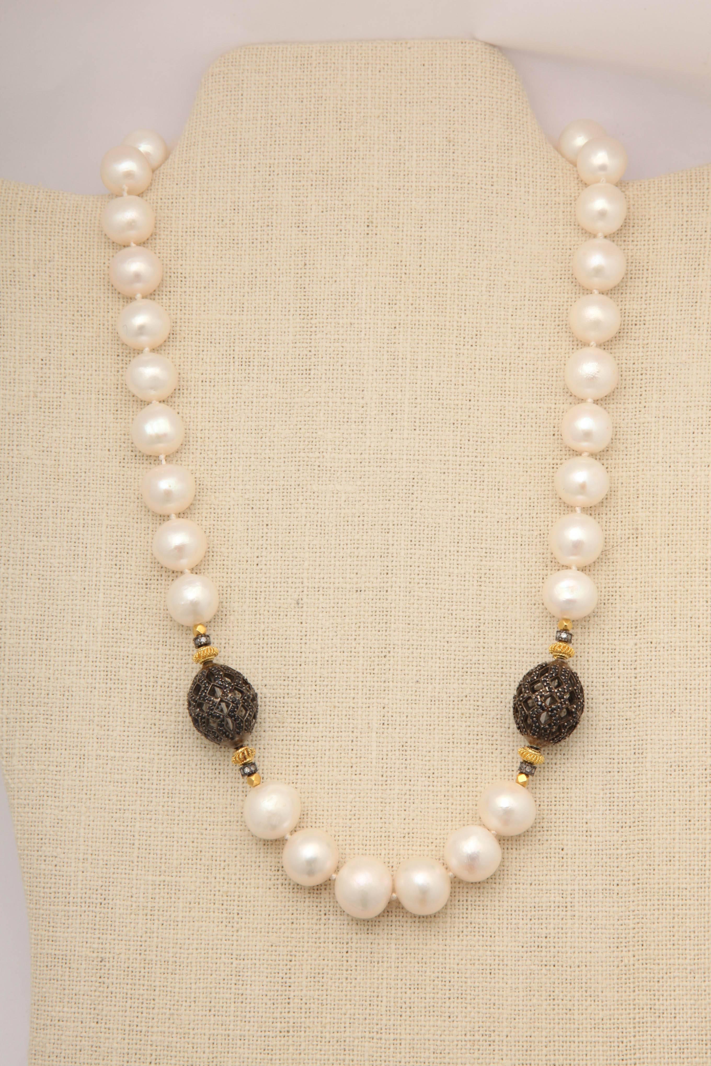 Fabulous 12-13 mm fresh water pearl necklace with faceted black spinels pave set in intricately cut silver oval beads. On either side of the silver spinel beads are 18 kt gold beads and silver and diamond rondeles. The necklace is finished with a