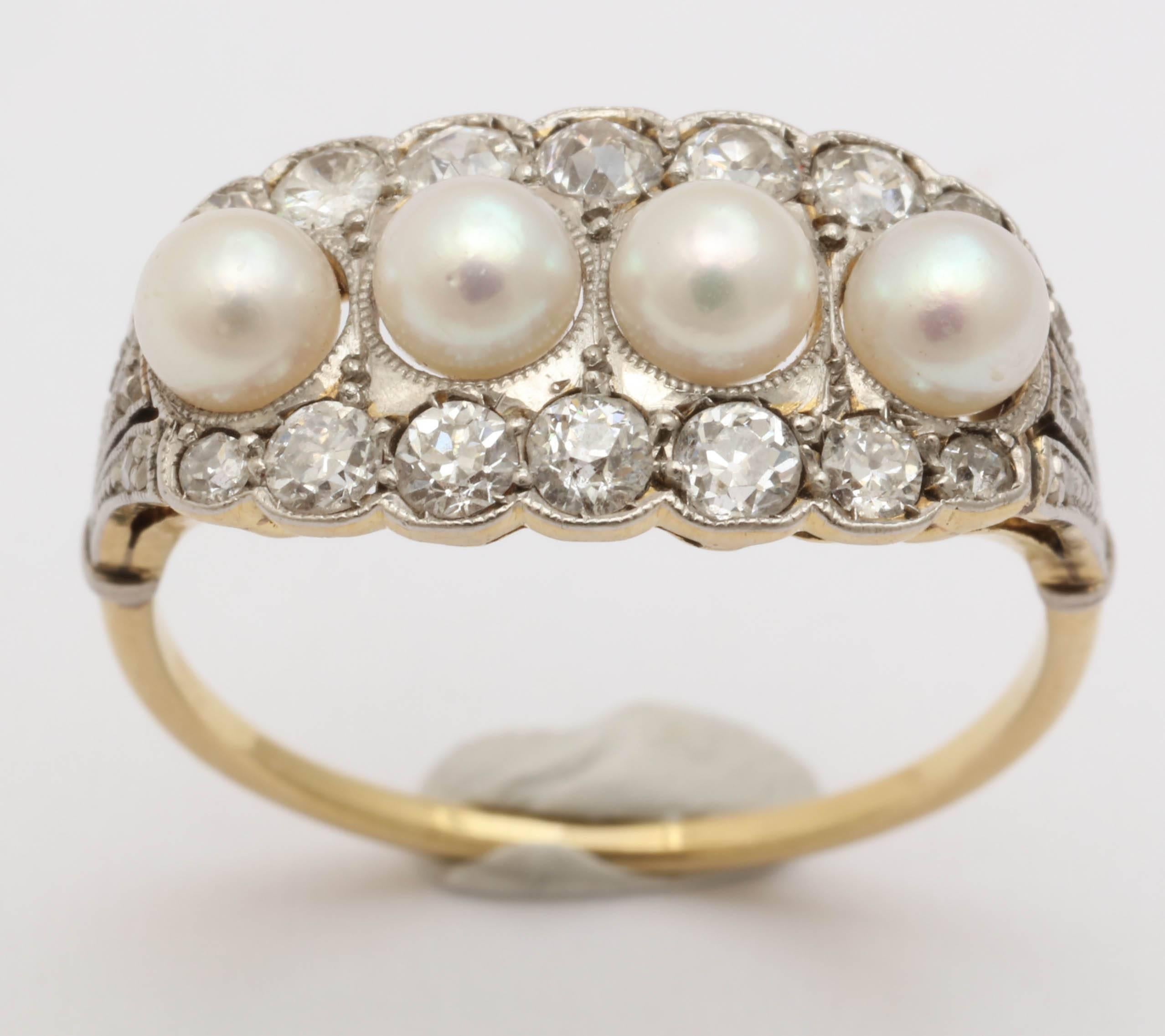 Edwardian English ring, platinum on 18K yellow gold. Set with 4 full natural pearls and 20 diamonds: row of 5 central diamonds on each side of pearls (approx. .07 -.10 ct), 2 smaller diamonds at rows' ends (approx .02 ct), 3 tiny diamonds on
