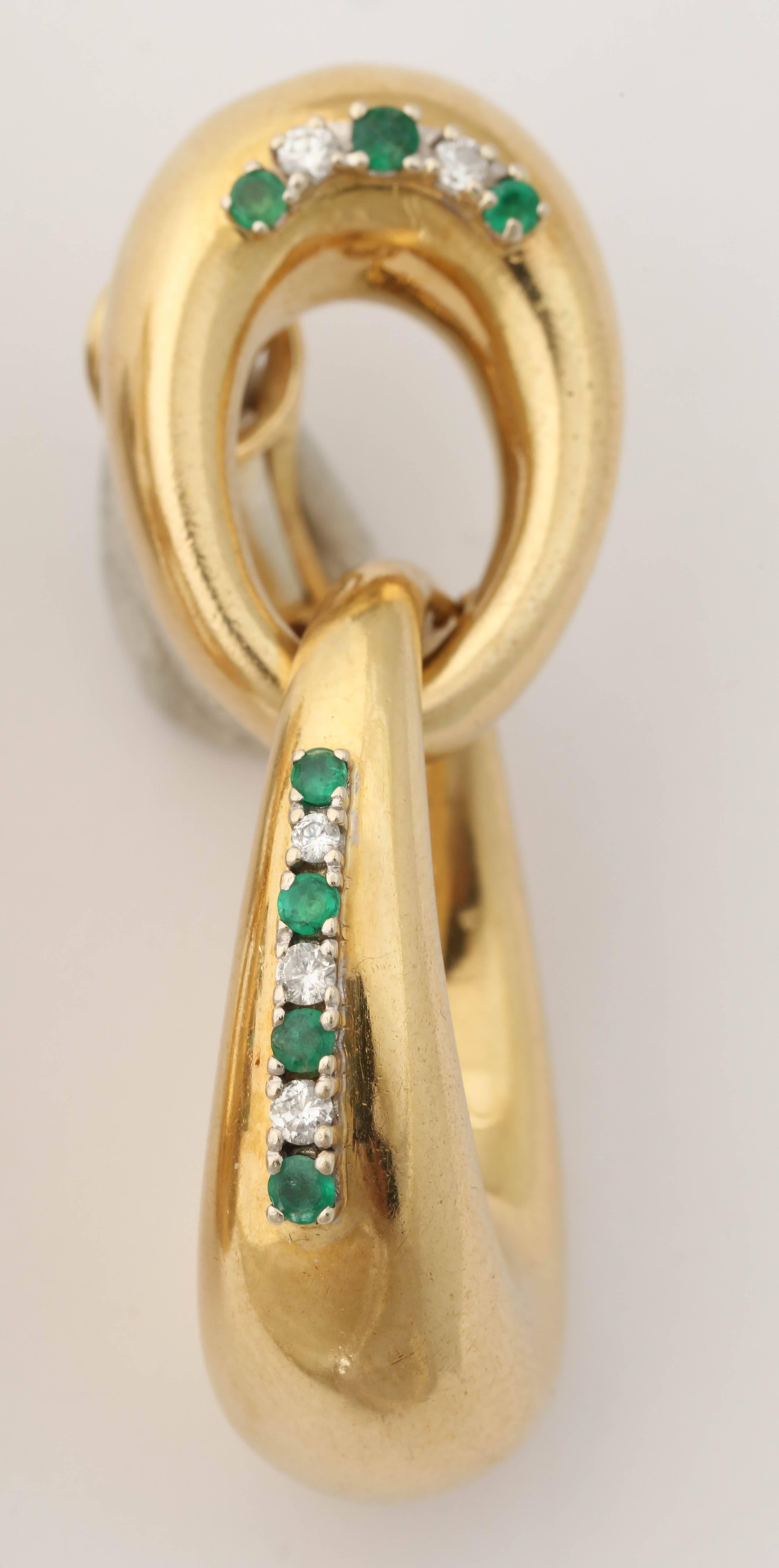 18kt yellow gold double loop Doorknocker earrings consisting of 14 faced beautiful color emeralds and 10 high quality full cut diamonds. European made in the 1960's.