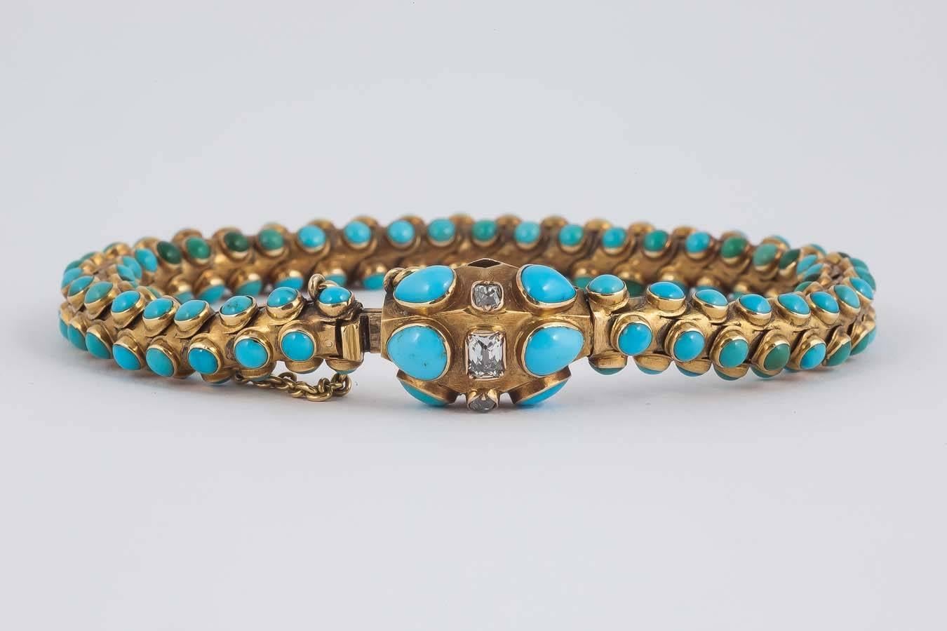 The cabochon cut turquoise bracelet is set with old cut diamonds in the clasp and resembles a serpent