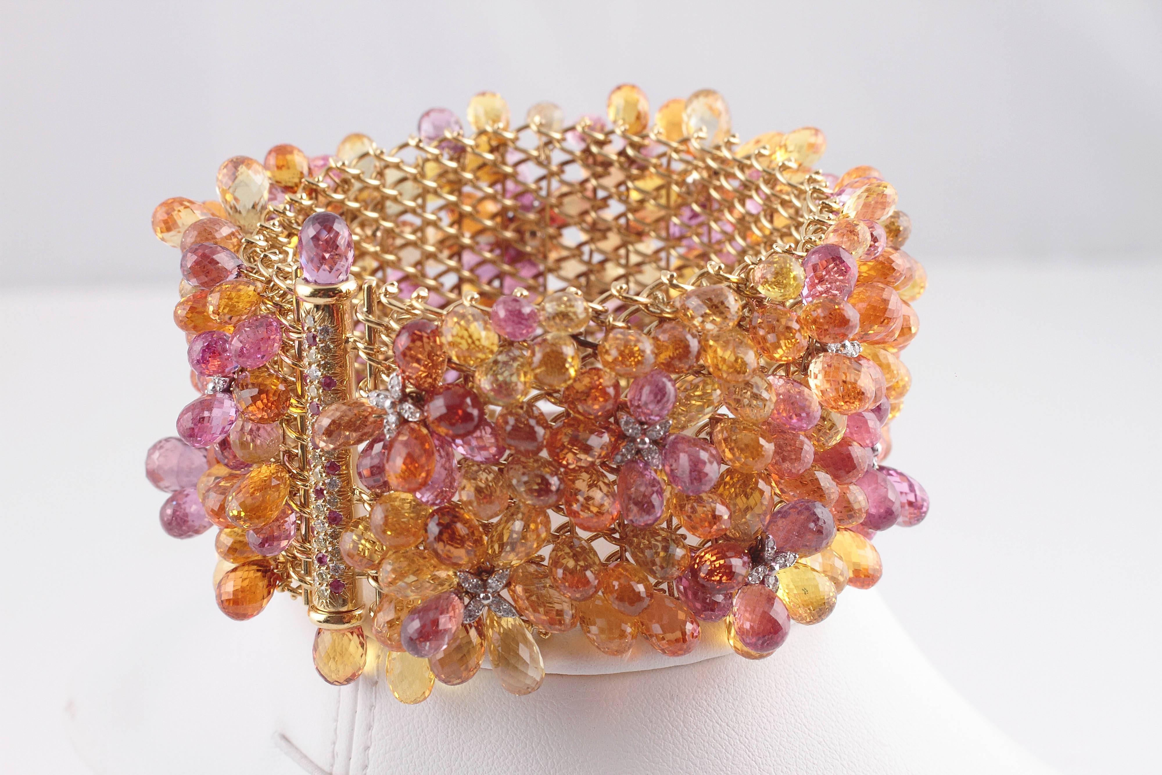 18 karat yellow gold, with over 500 carats of multi-color sapphires all exquisitely designed and executed.    The lucky lady that wears this bracelet into the room can be guaranteed that the entire room will stop to check it out.  Worthy of the red