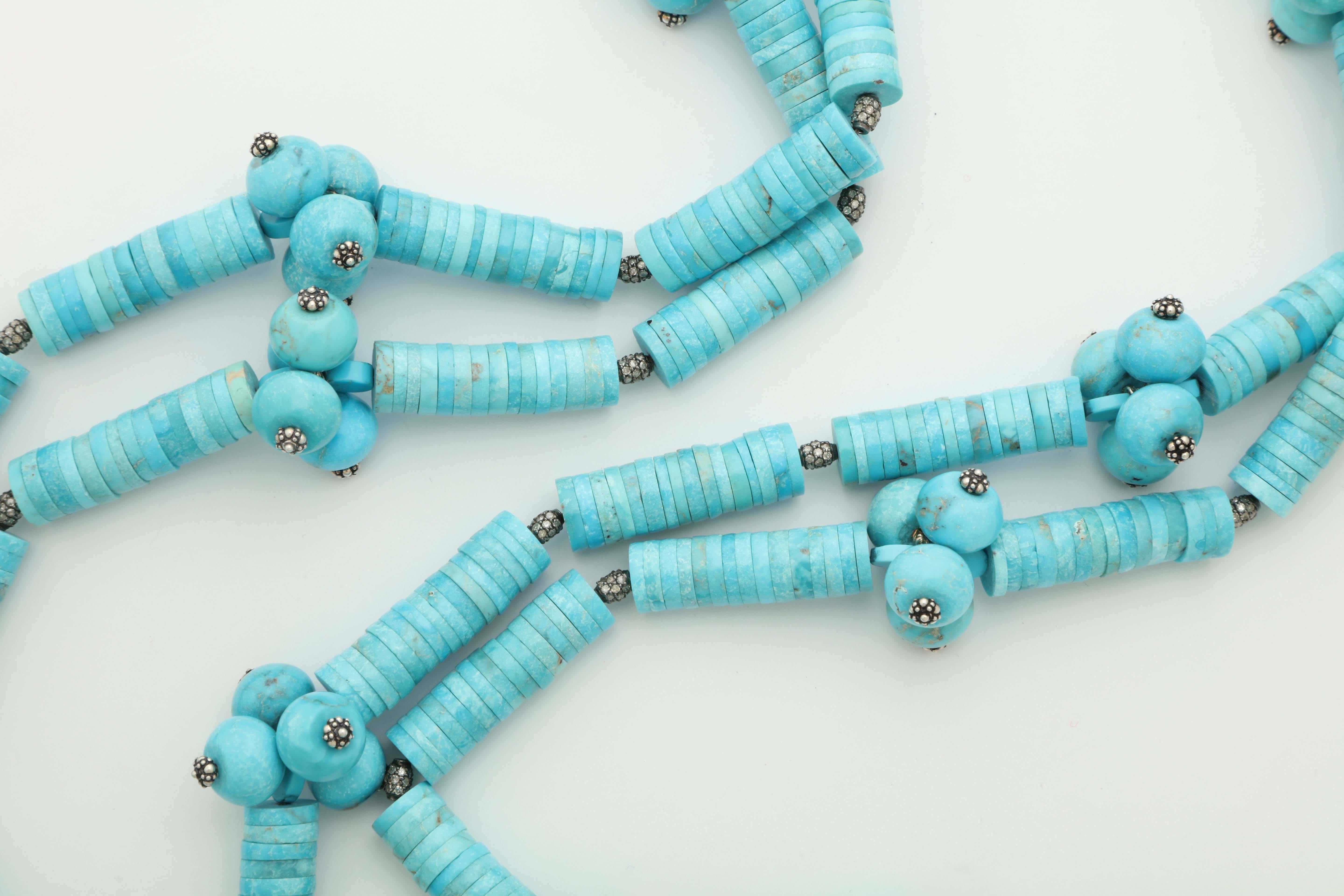 A necklace composed of turquoise discs, turquoise beads, rhodium plated sterling silver and pave diamond beads and rhodium plated sterling silver headpins. 
Length: 58 inches