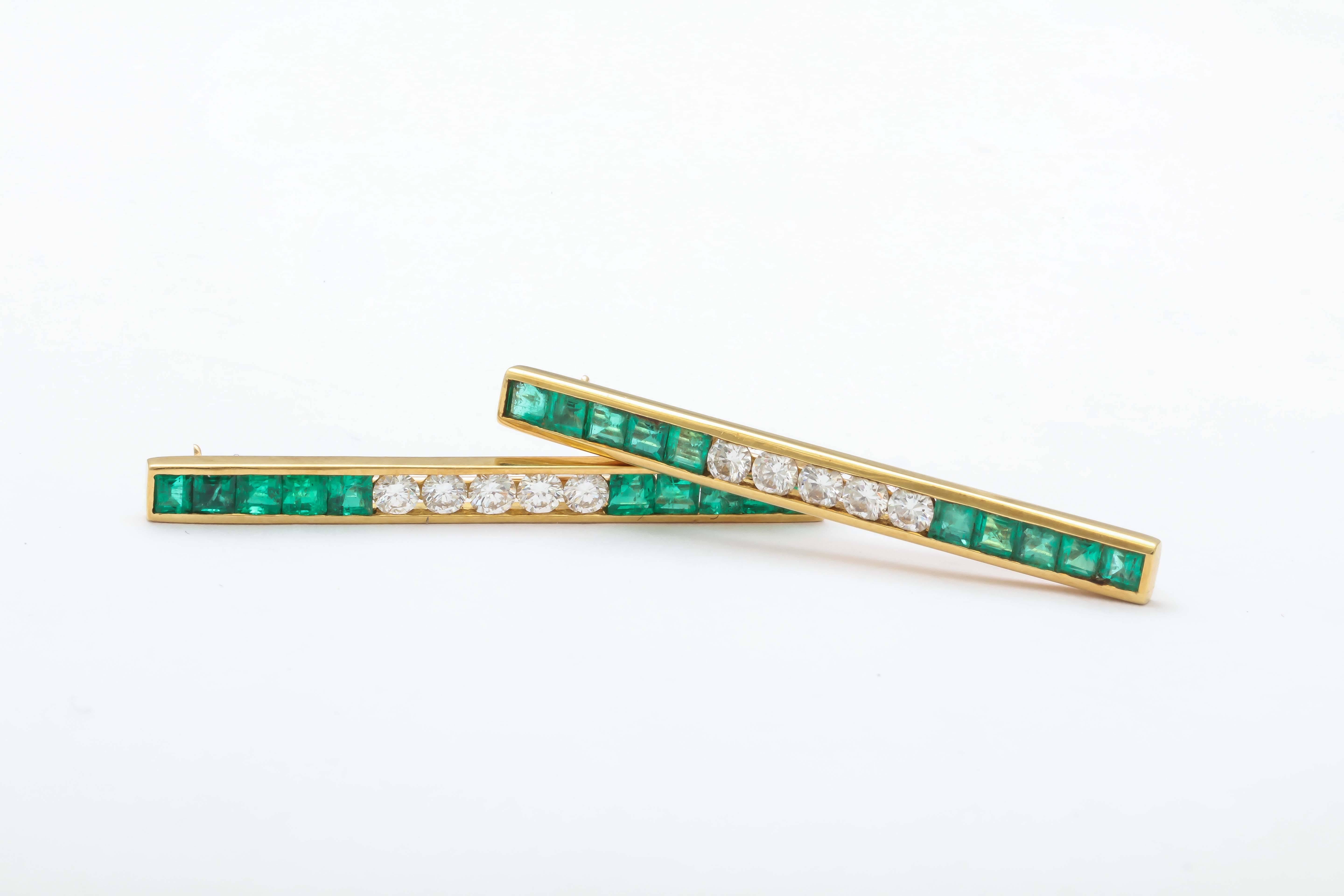 Pair of Square cut vibrant Emerald & Round  - full cut - clean & white Diamonds.
Each pin has 10 Emeralds & 5 Diamonds.  One is marked - 18t and T & Co.  The matching pin is only marked 18t.  Beautiful & crisp.

