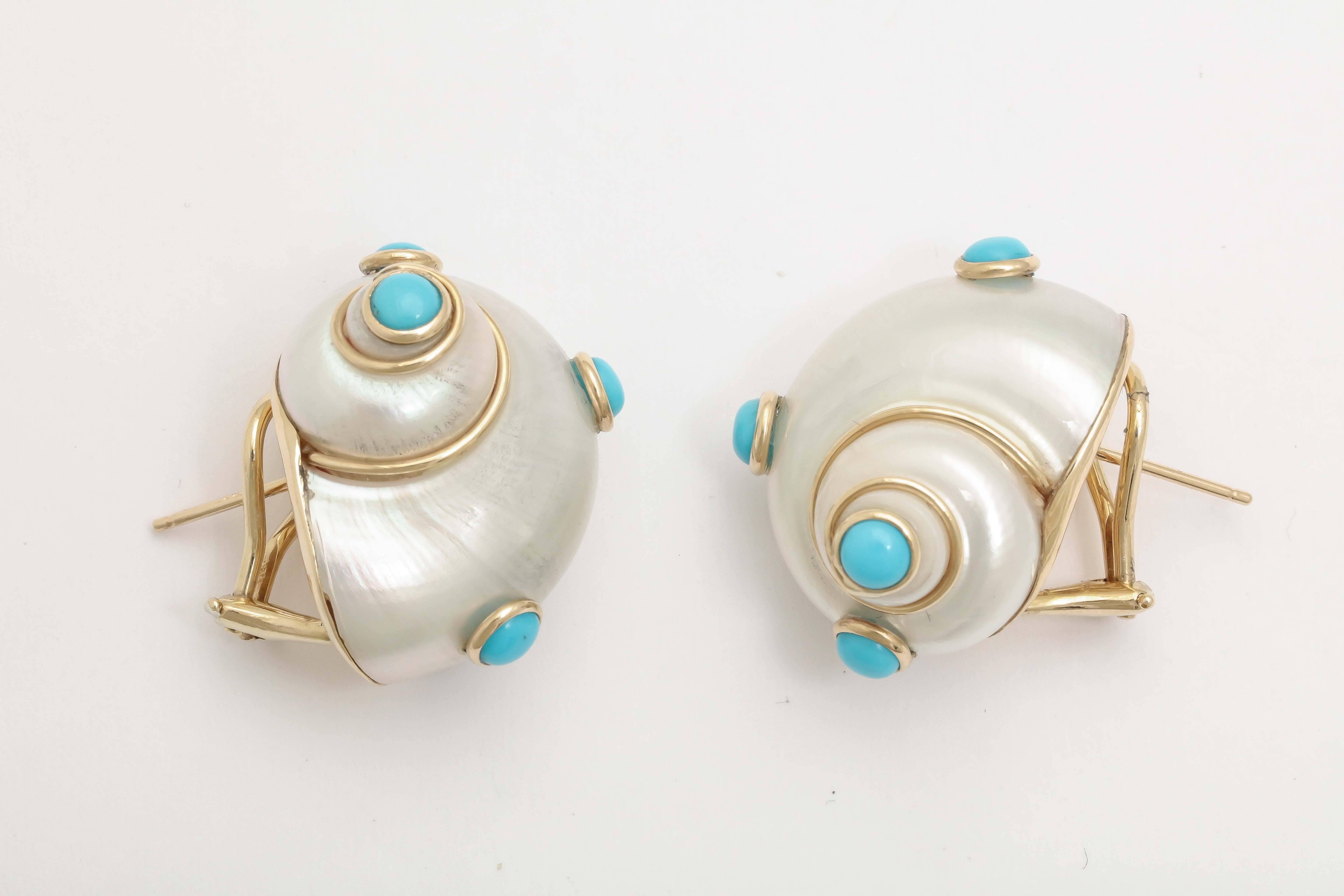 A new twist.  Shell Earrings set in 14t Yellow Gold and bezel set with Cabochon Turquoise Stones.  Left Ear - the Shell goes up, while the Right Ear is oriented with the Shell going down.  Omega backs and pierced, as well.