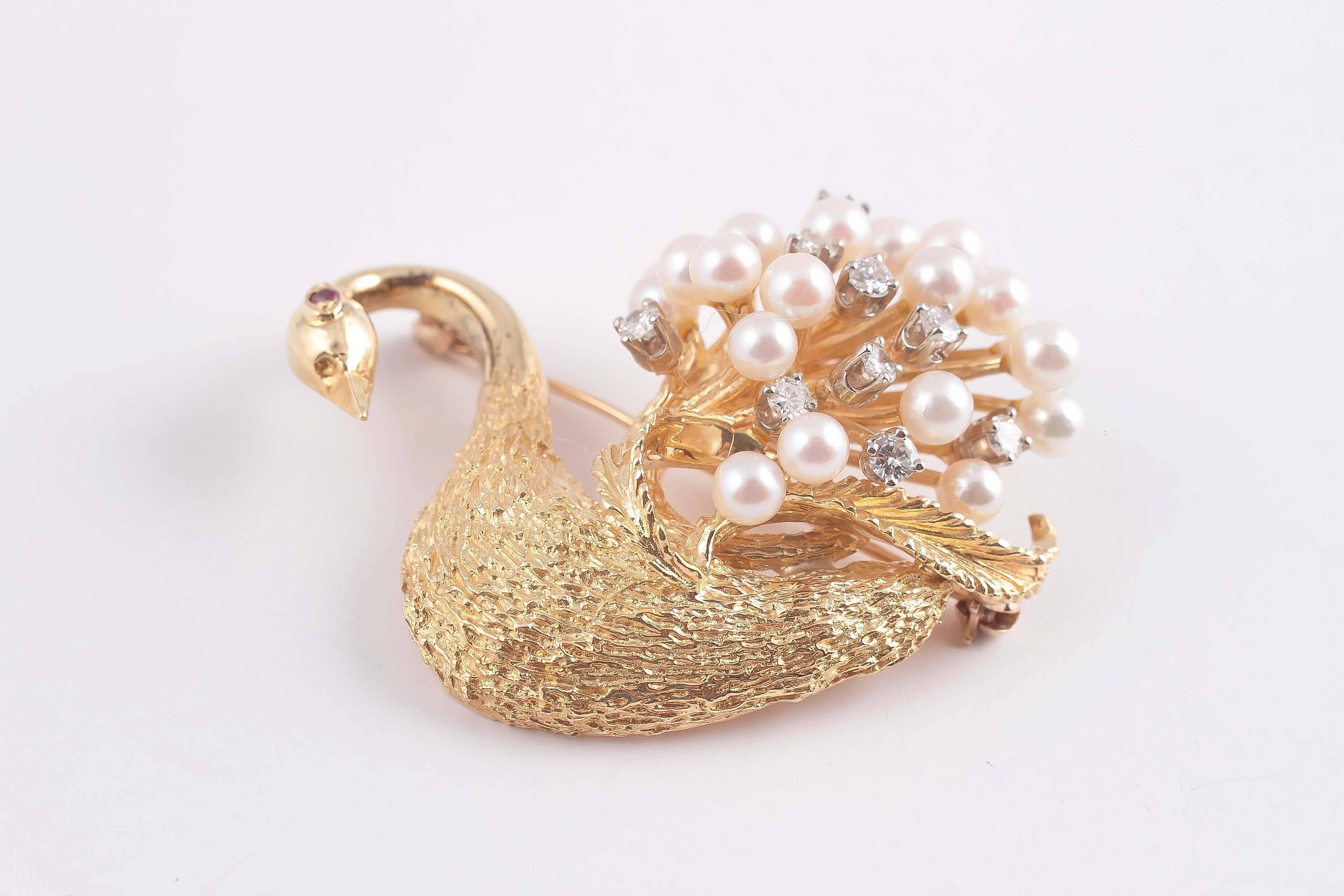 18 Karat yellow gold, textured swan gracefully swimming with pearls and diamonds tucked into feathers.  A single ruby completes the picture as the eye.  A bold 3 dimensional look from the mid-century 