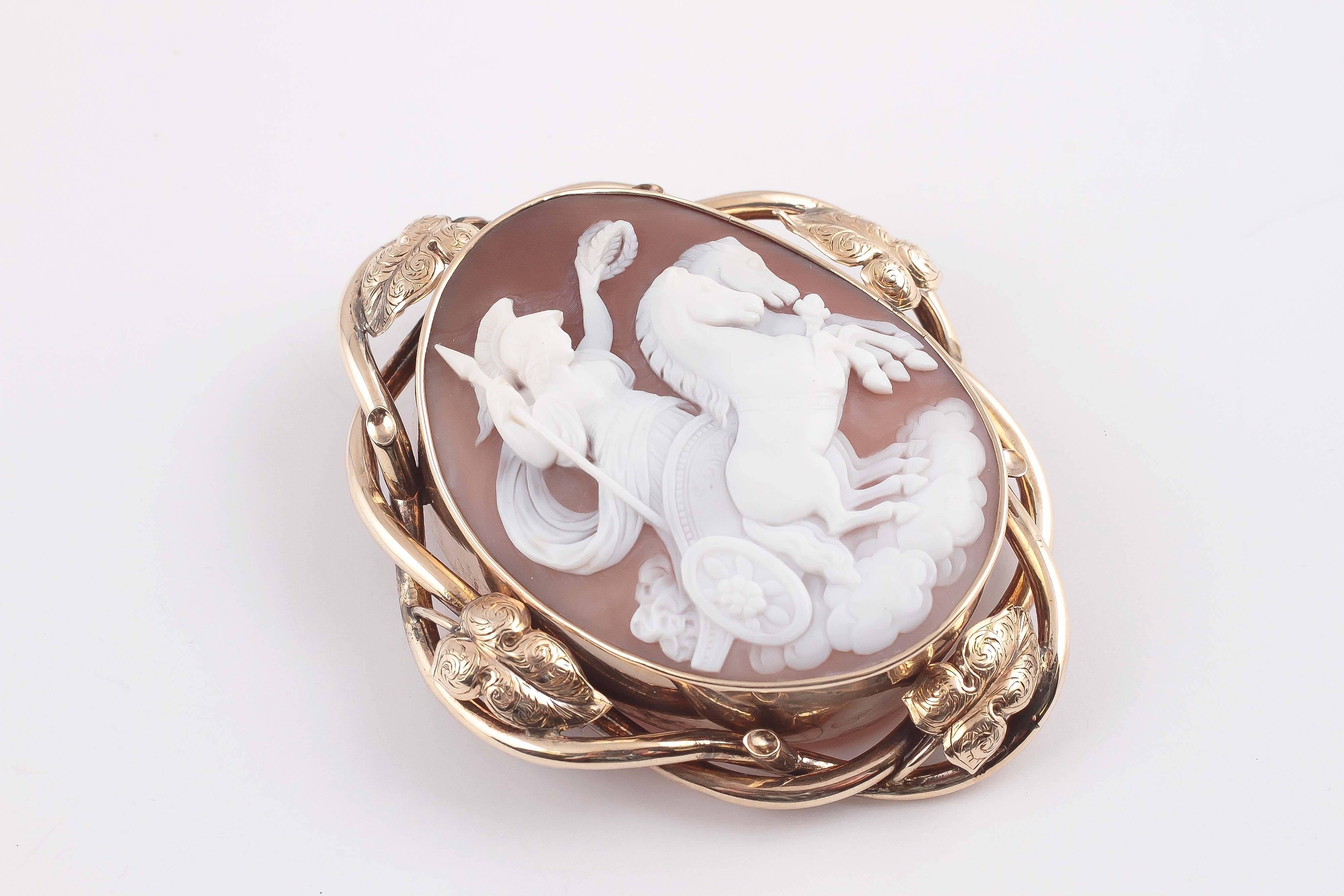 Victorian carved shell cameo ornately framed in intertwining 10 karat yellow gold mounting.  A great statement piece and beautiful to wear.  