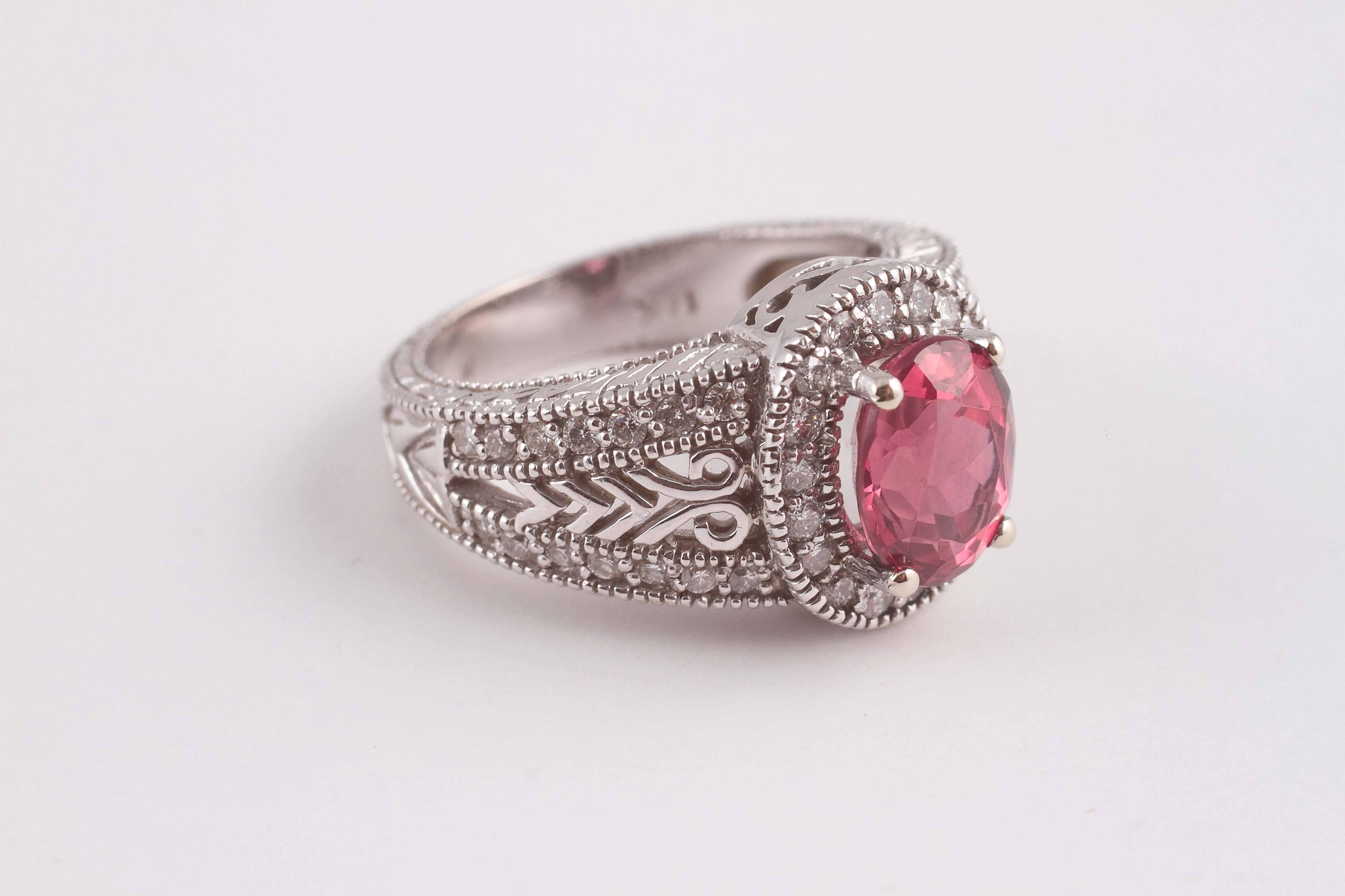 A natural spinel set into a filigree 14 karat white gold and diamond ring, size 7, GIA certificate on the center confirming the stone is naturally mined.  A truly beautiful look and a brilliant gem.  