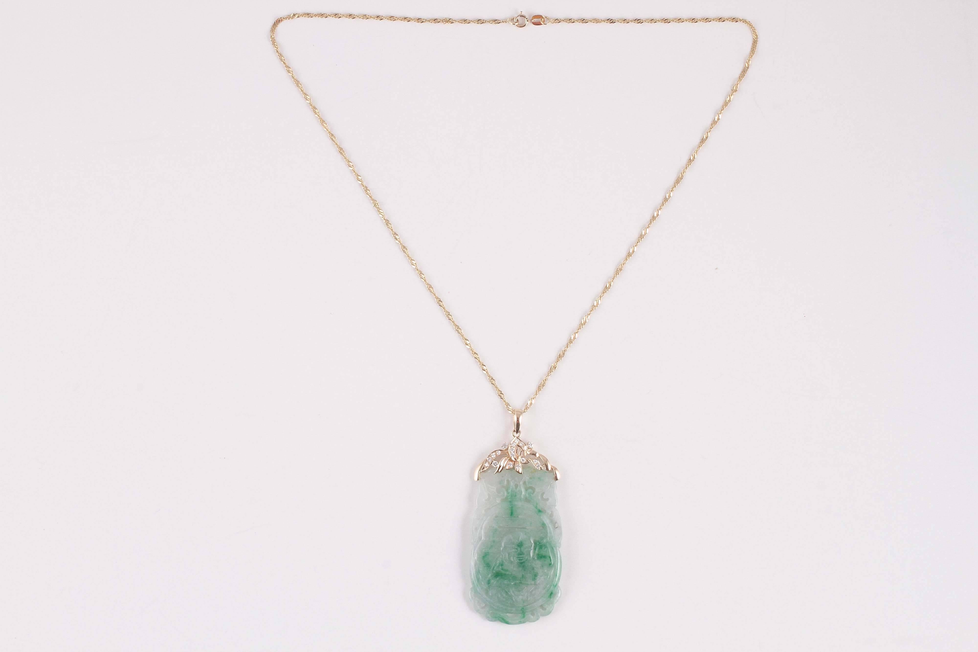 18 karat yellow gold, pendant measures 60.00 mm, chain 18 inches.  Light green mixed into the beautiful jade is sometimes called 