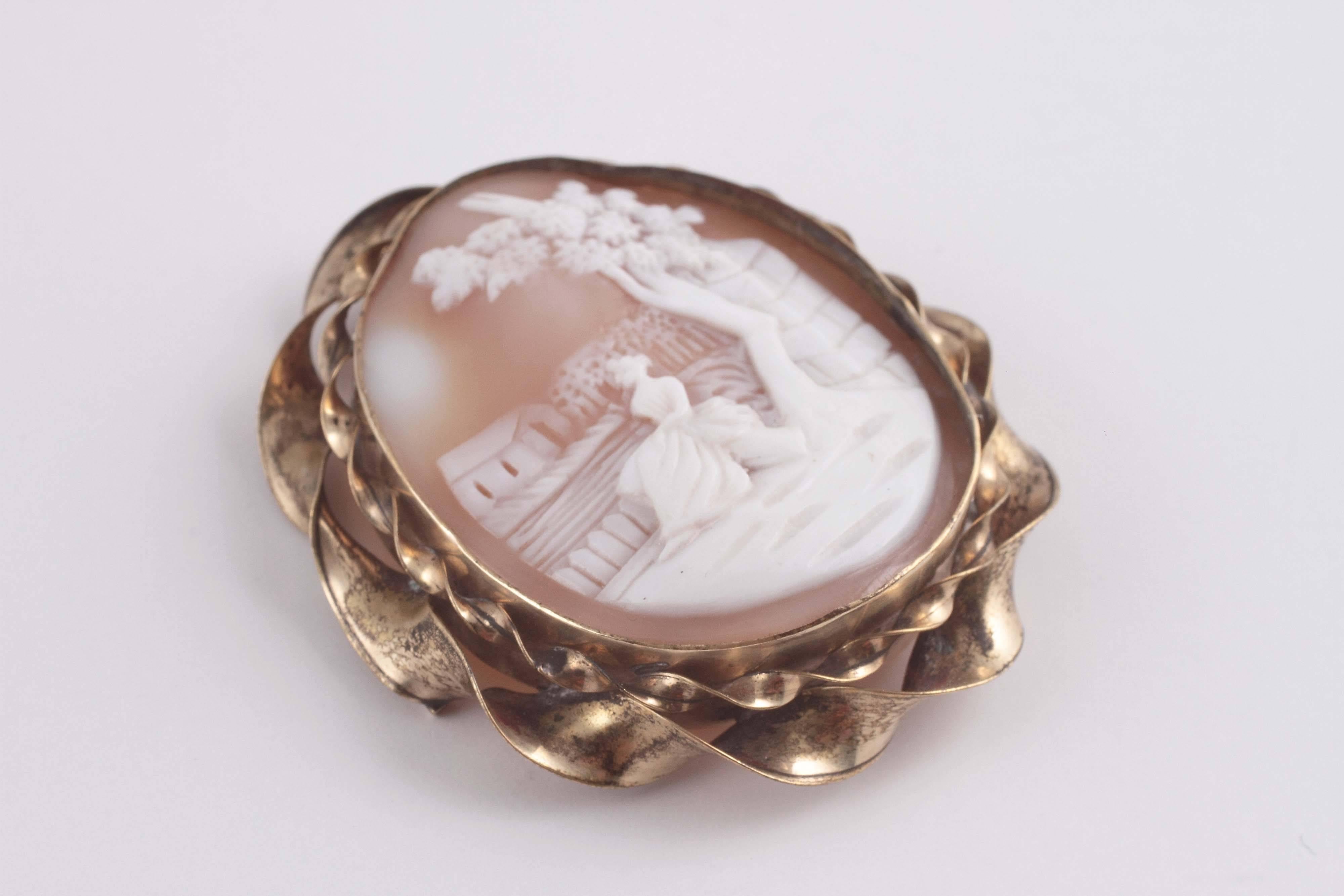 Idyllic scene on shell cameo surrounded with yellow gold frame.  A sweet reminder of a slower time.  