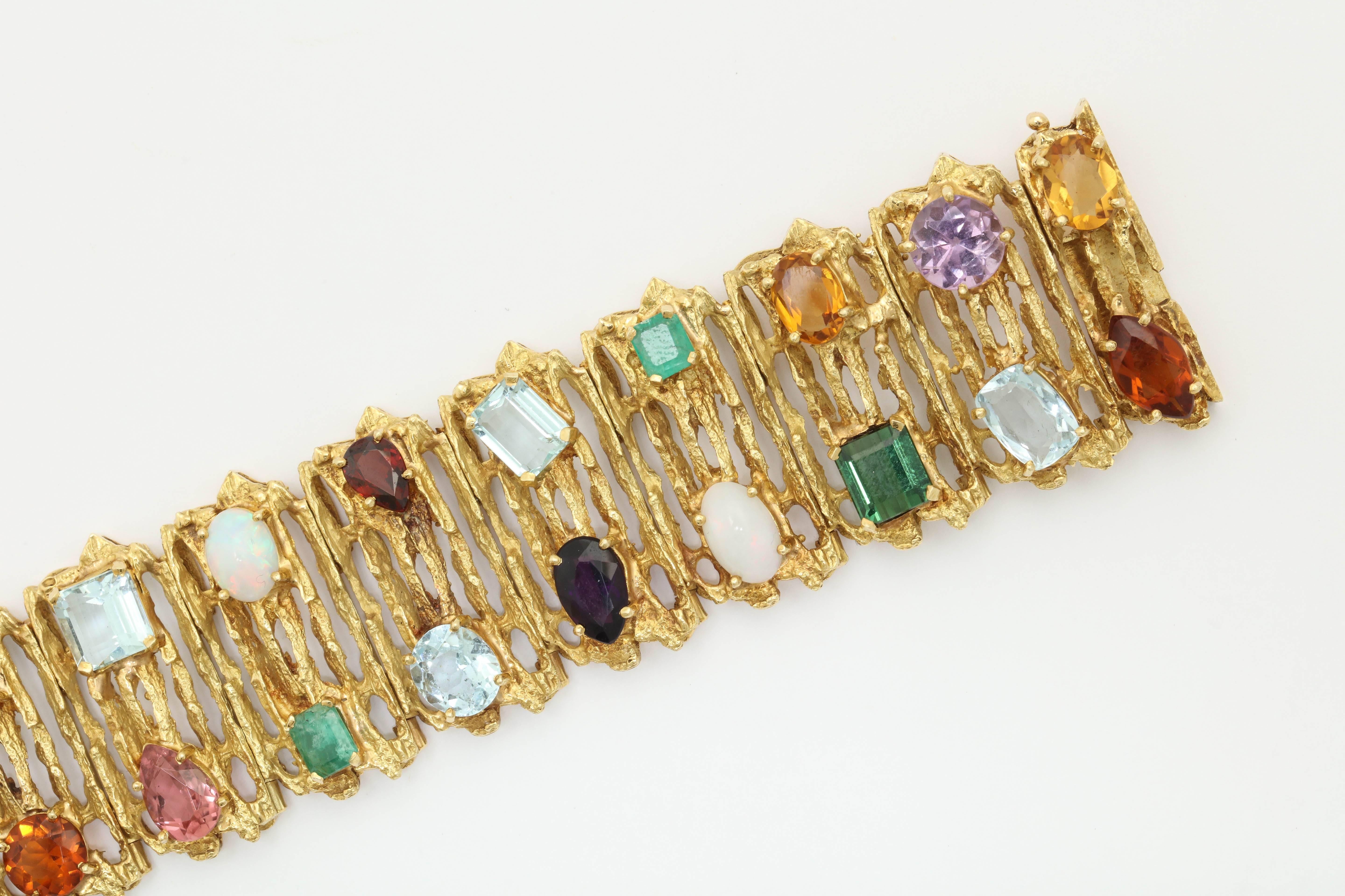 18kt Yellow Gold Textured Bracelet Consisting of Multi-Colored Gem Stones consisting of :Aquamarines,Garnets,Amethysts,Emeralds,Opals ,Moonstones &Green Tourmalines With Citrine Faceted Stones thru-out Bracelet.Signed H.Stern Designed in the 1960's