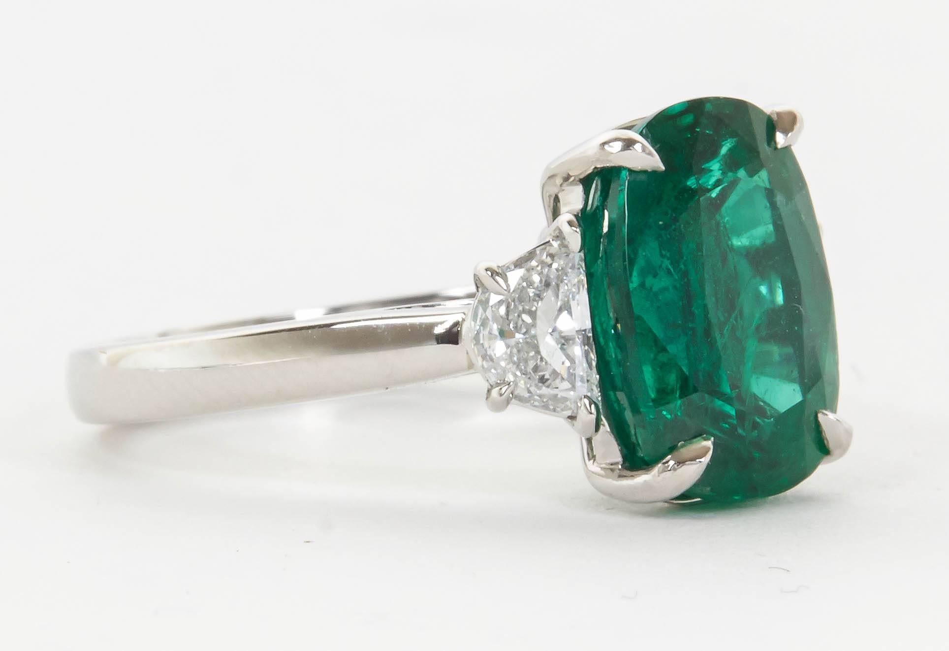 Pictures do not do this Emerald justice! 

A very fine green color and very brilliant, this 4.21 carat Emerald is certified by GIA and has minor oil treatment F1. 

The center stone is set with .54 carats of diamonds in platinum.

A fabulous