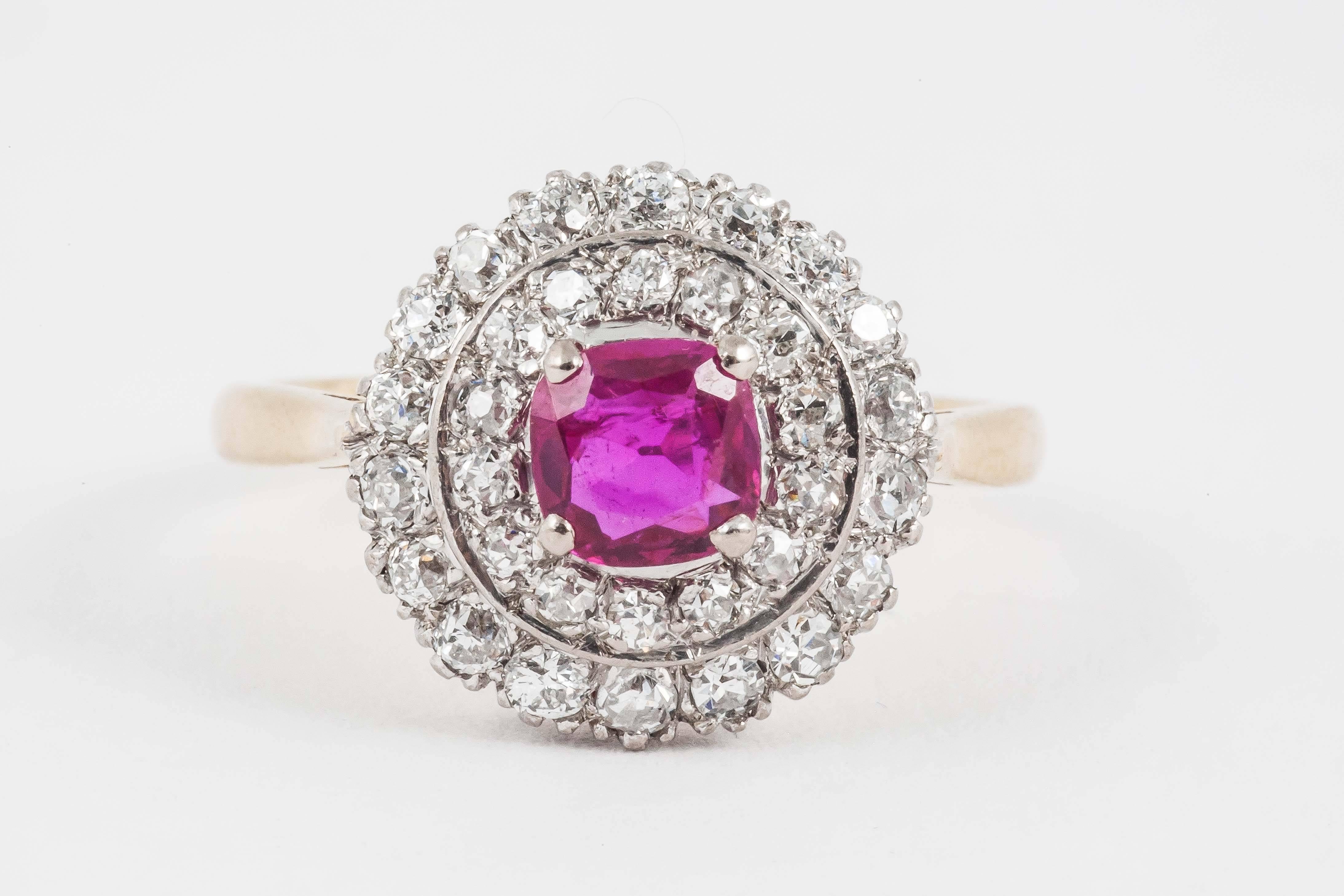A circular shaped 1950's vintage cluster ring with central Burma ruby surrounded by two rows of brilliant cut diamonds set in 18 carat white gold and mounted in 18 carat yellow gold.
Ring size 8.5 USA, Uk size Q.
1950's Vintage piece in the
