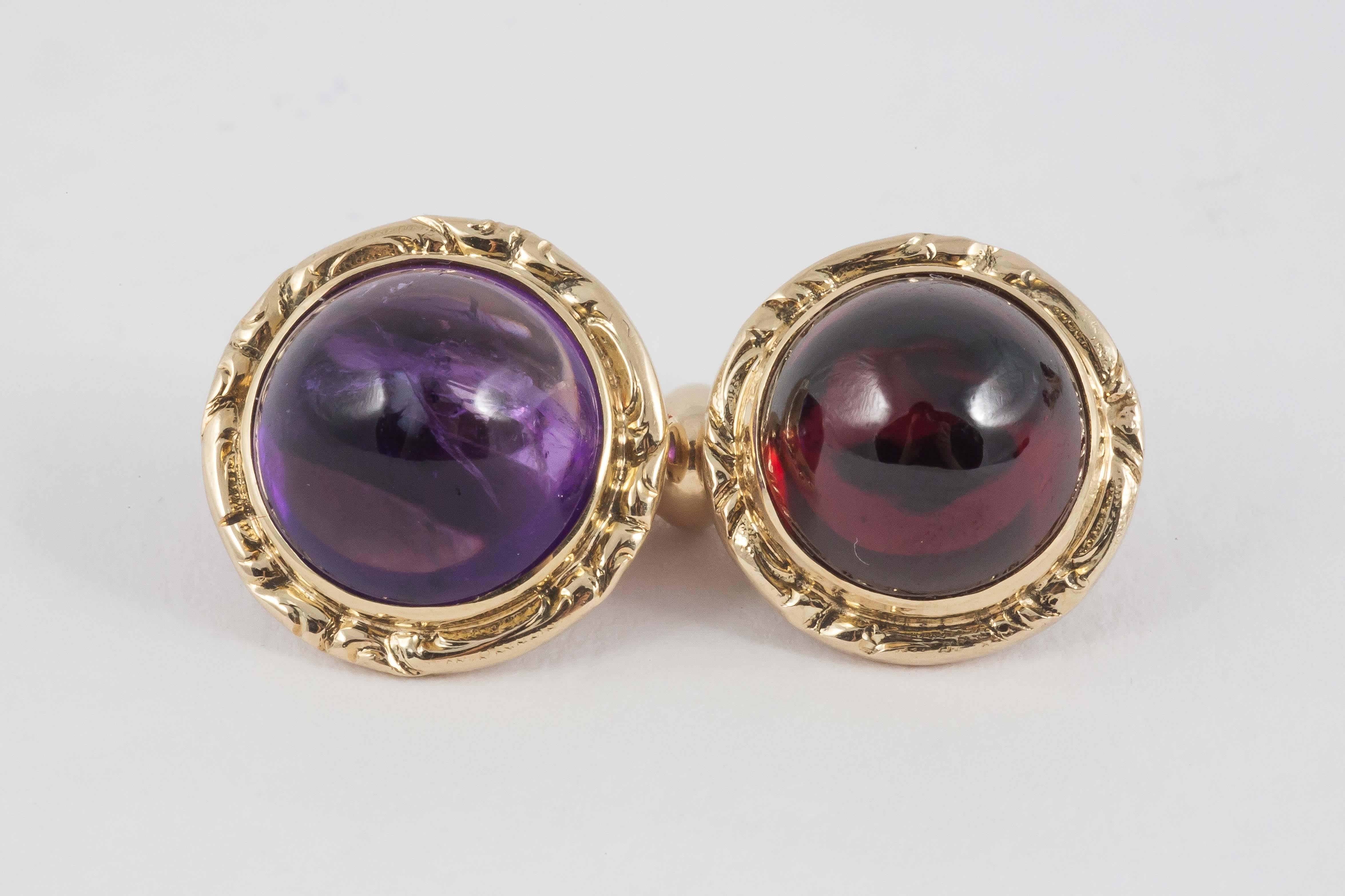 A pair of 14kt gold carved circular cufflinks with two,Cabochon Garnets and two Cabochon Amethysts, with Austrian marks.c.1950