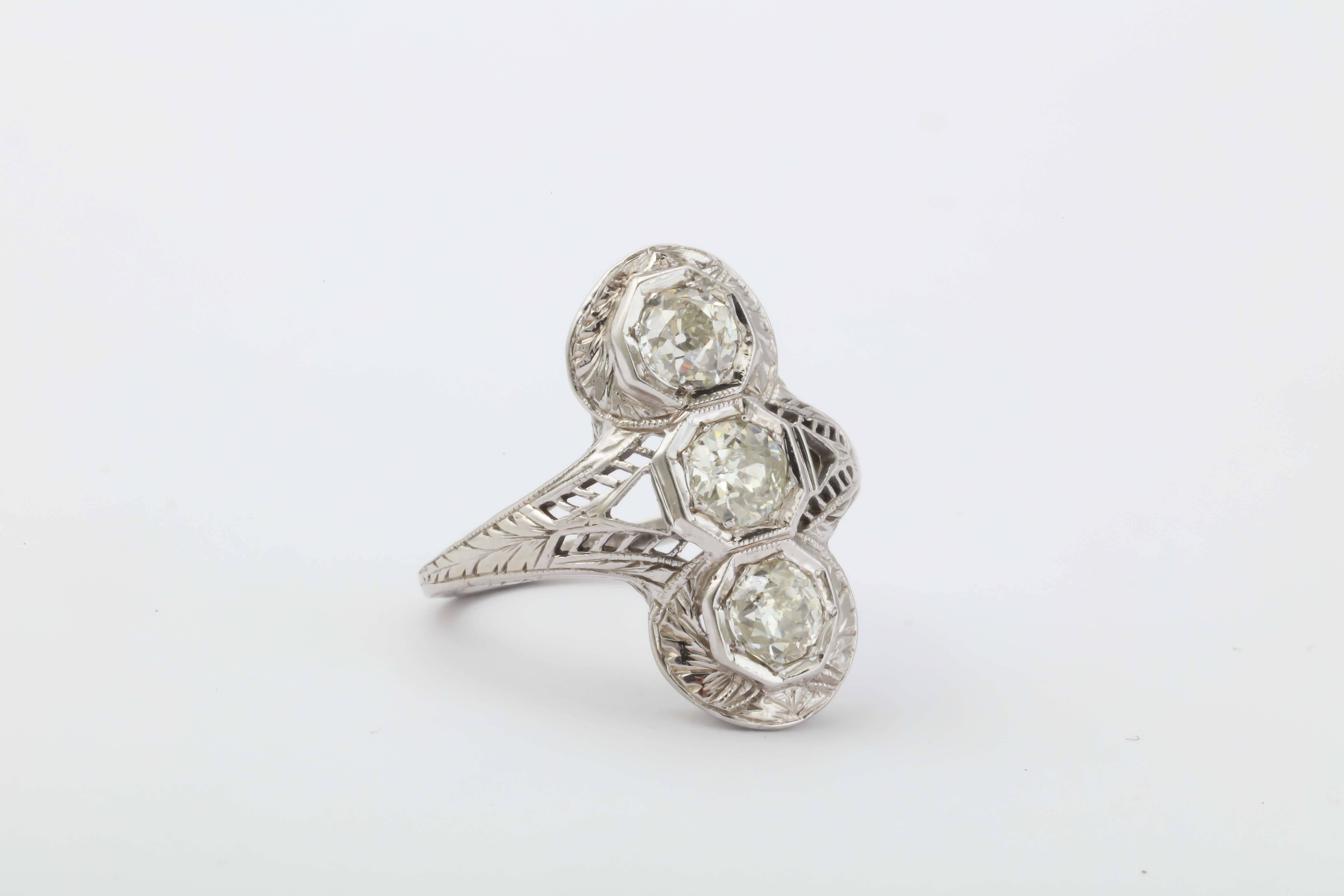 18kt White Gold Filigree Ring - Ca 1910 set with three full cut clean & white Diamonds.  Very lovely. Total weight of Diamonds - approximately 1.25cts.

