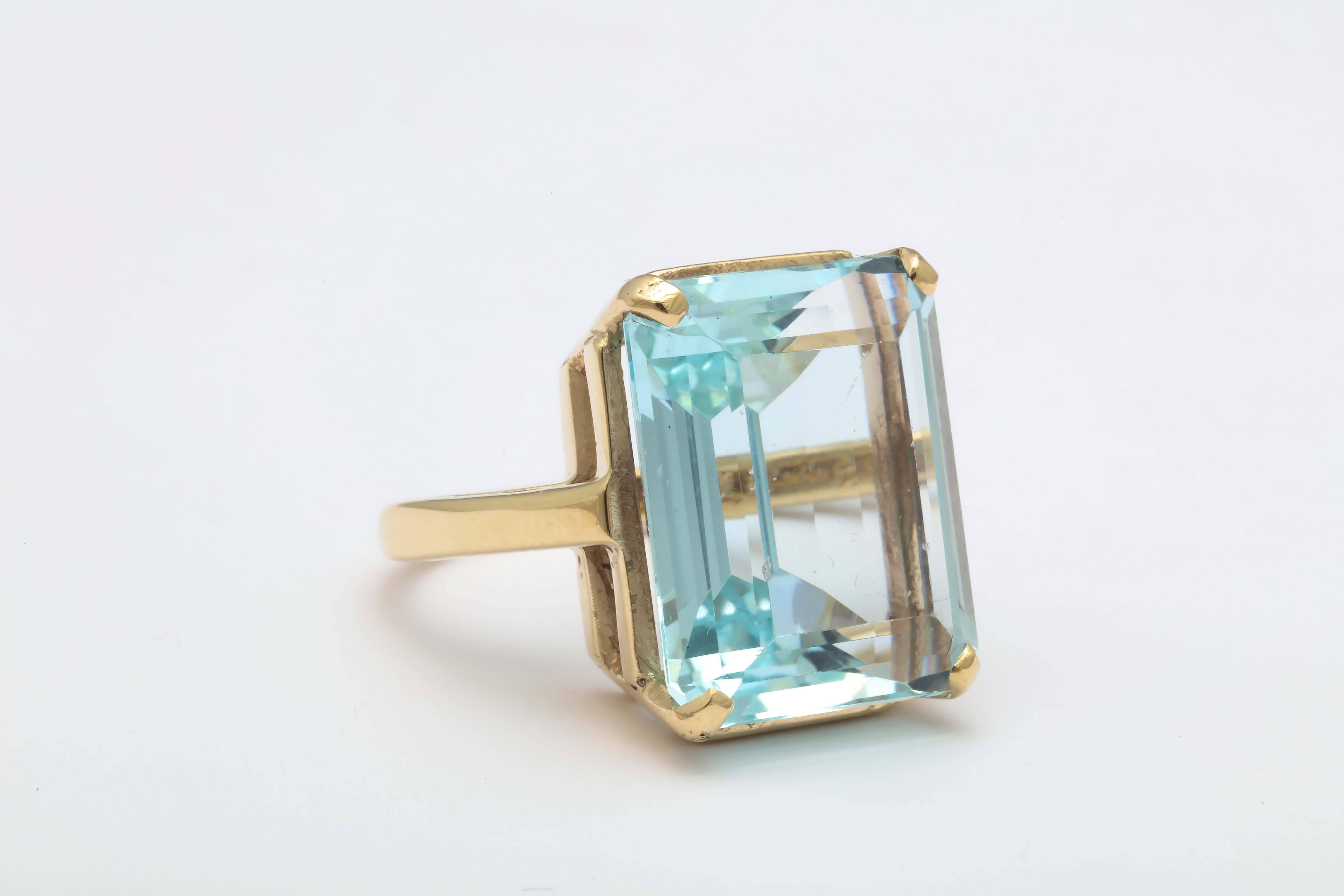  Emerald cut Aquamarine - approximately 18-20carats it is set in 14t Yellow Gold Retro Mounting.  The yellow gold mounting in contrast to the mostly White Gold mountings of the period.  Good cook and very rich looking set in Yellow Gold.