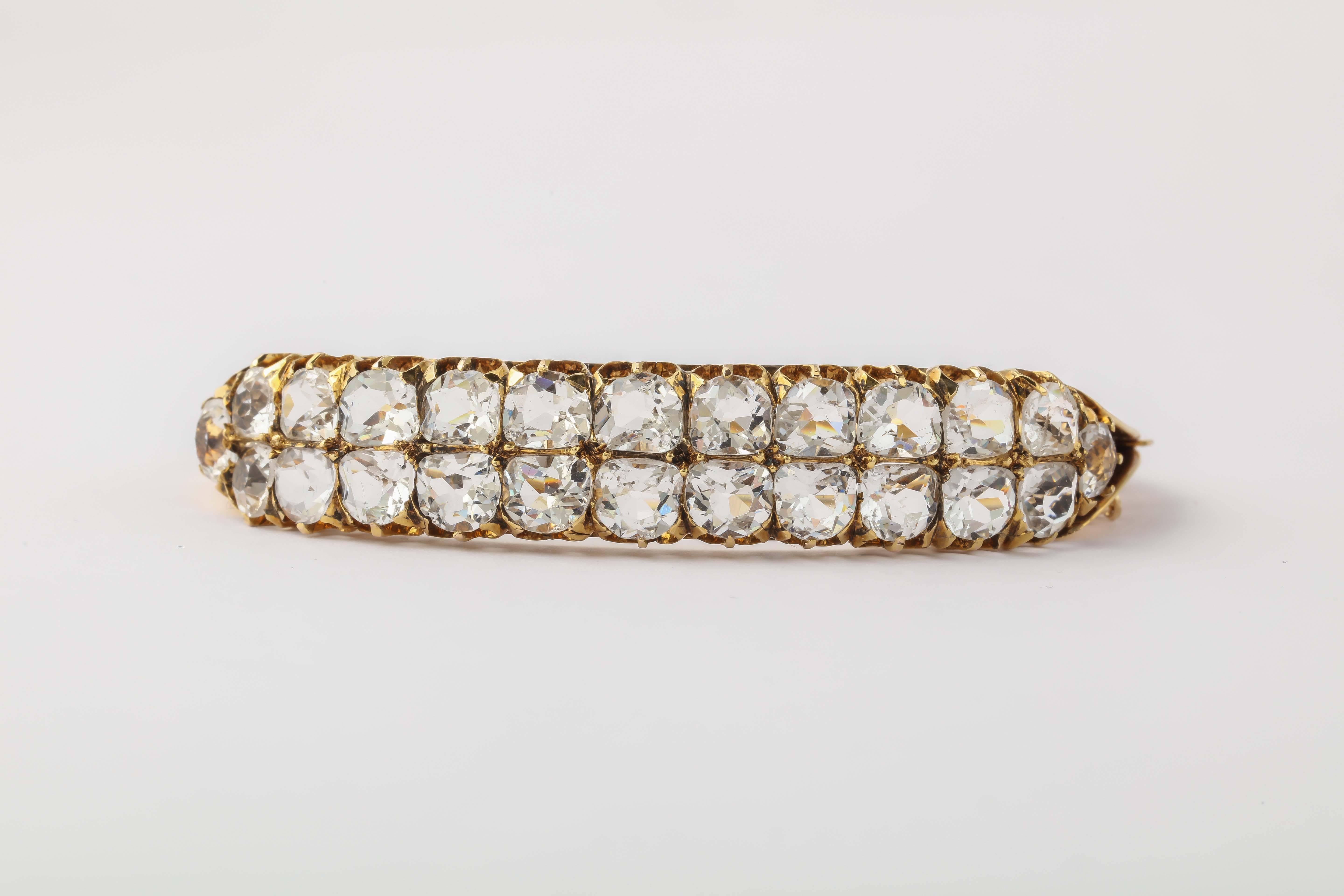 14kt Yellow Gold hinged bangle set with a double row of faceted White Sapphires or crystal.  Ca1910 - Edwardian. Next best thing to Diamonds. Prong set with heavy claw settings.