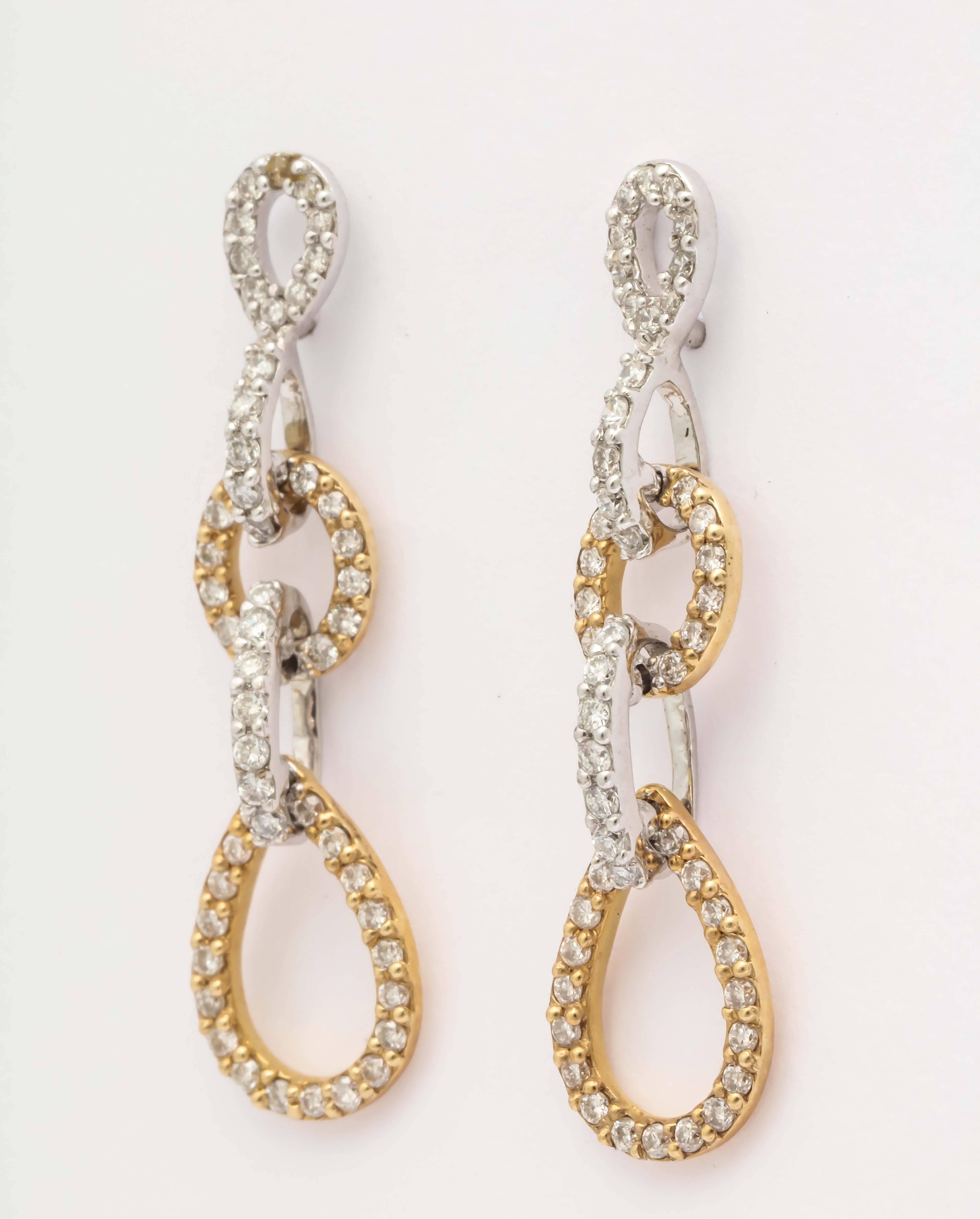 The earrings are microset diamonds in yellow and white 14 kt gold. The diamond weight is 1.26 cts. The length of the earrings is 30 mm long and 8 mm wide at the bottom. Perfect for a refined and elegant woman. 