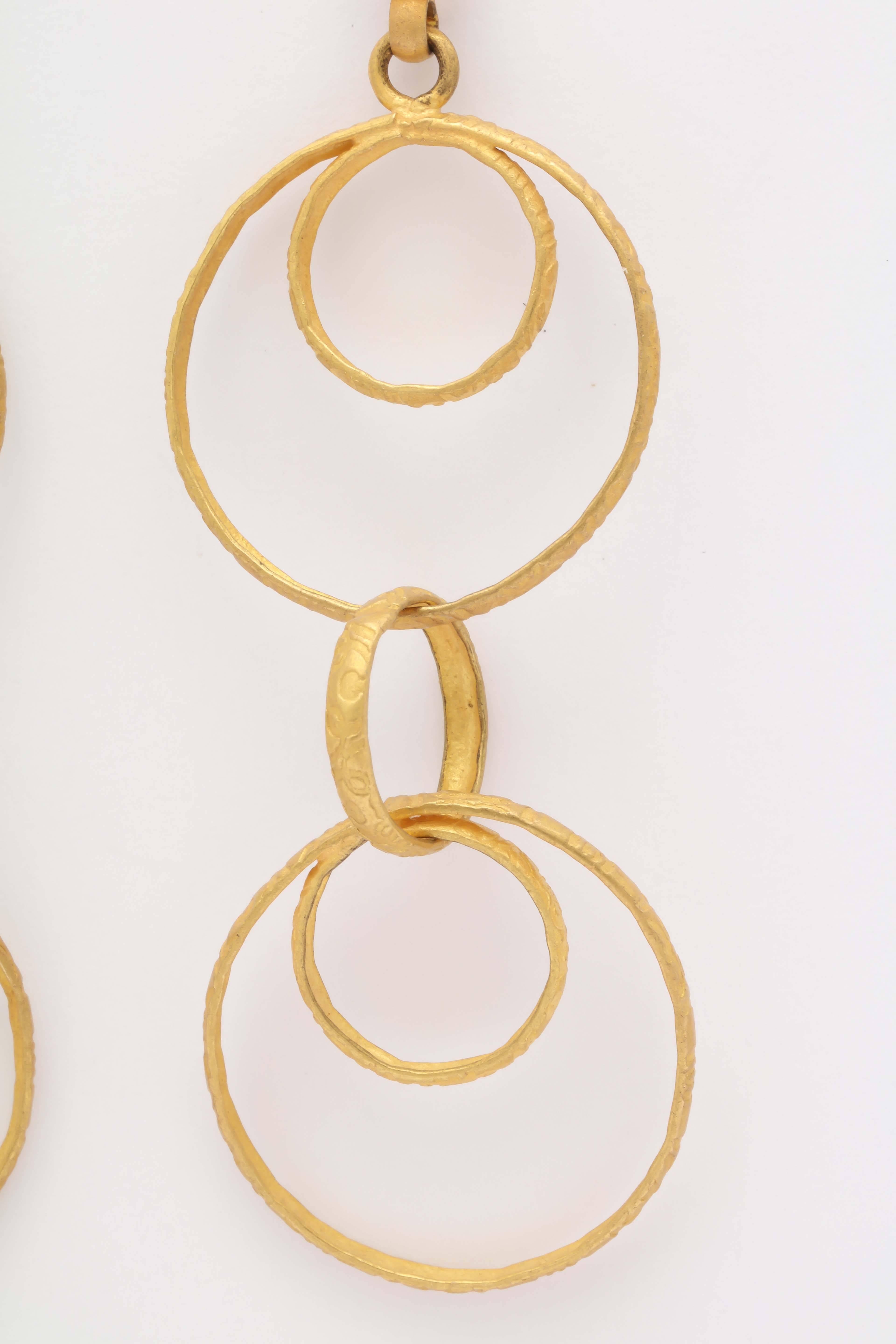 Light yet rich looking 22 kt  multihoop earrings. The long fish hook ear wires are very secure. The interlocking hoops make the earrings dangle and rotate beautifully. These earrings bring out the gypsy in you!