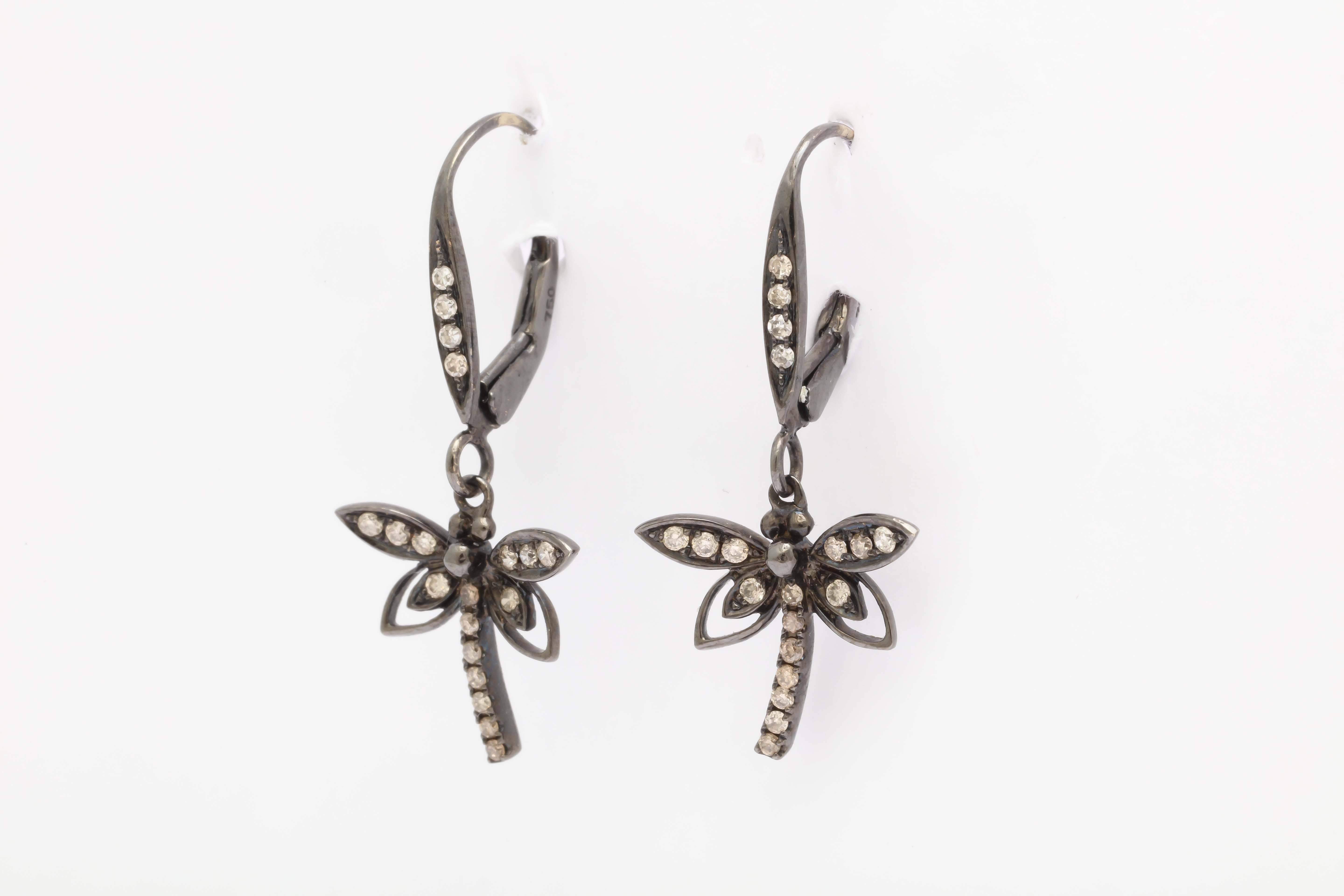 These  lovely dragonfly earrings are in 18 kt white gold with a black rhodium plating to make the diamonds pop. The total length is 11/2in long and 1/2 in. wing span. The Euro-wires close with a spring mechanism for extra security.