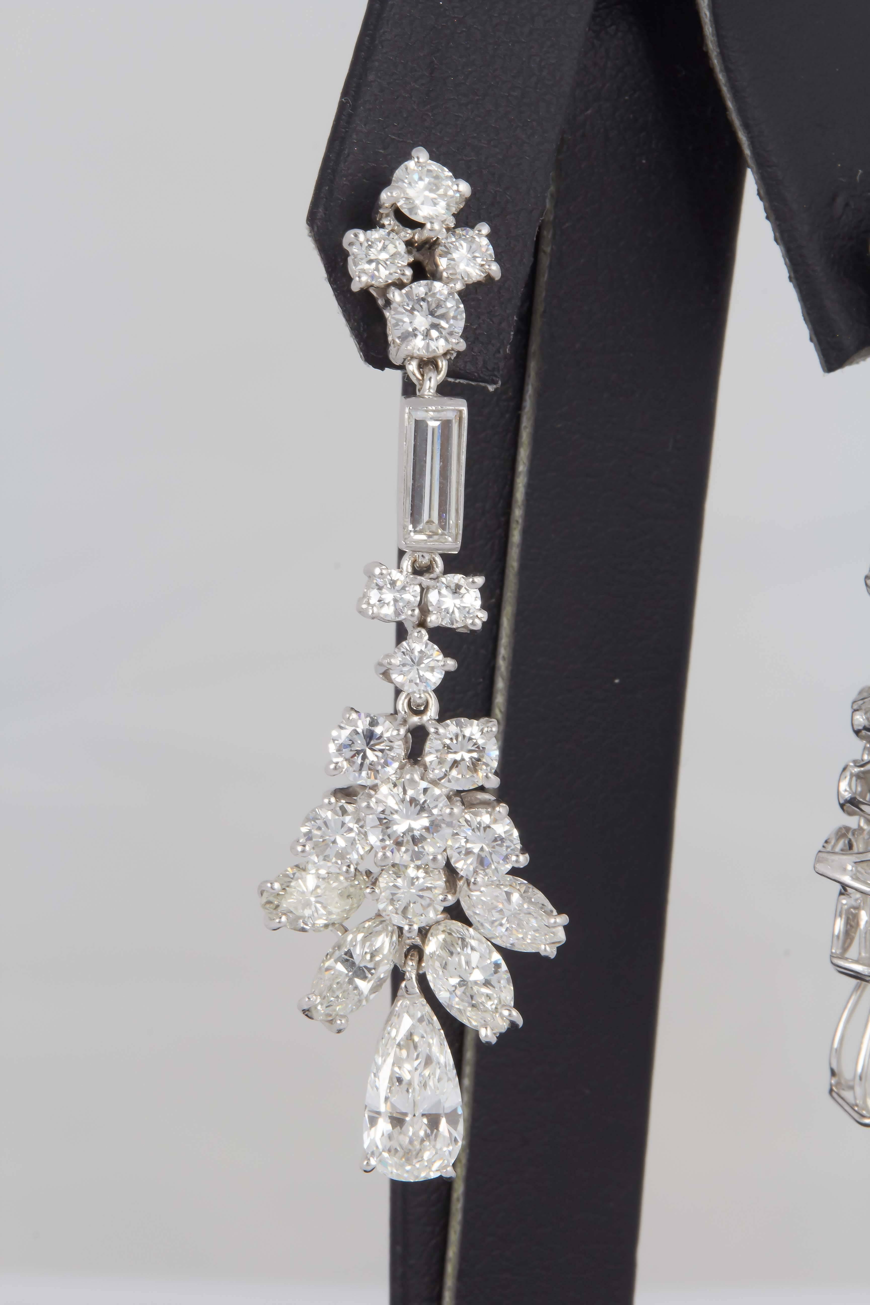 This Earring features:
2 pear shape diamonds 1.80 Cts.
Round Brilliant Diamonds 6.50 Cts.
2 baguette  diamonds  0.40 cts. 
Circa  1950