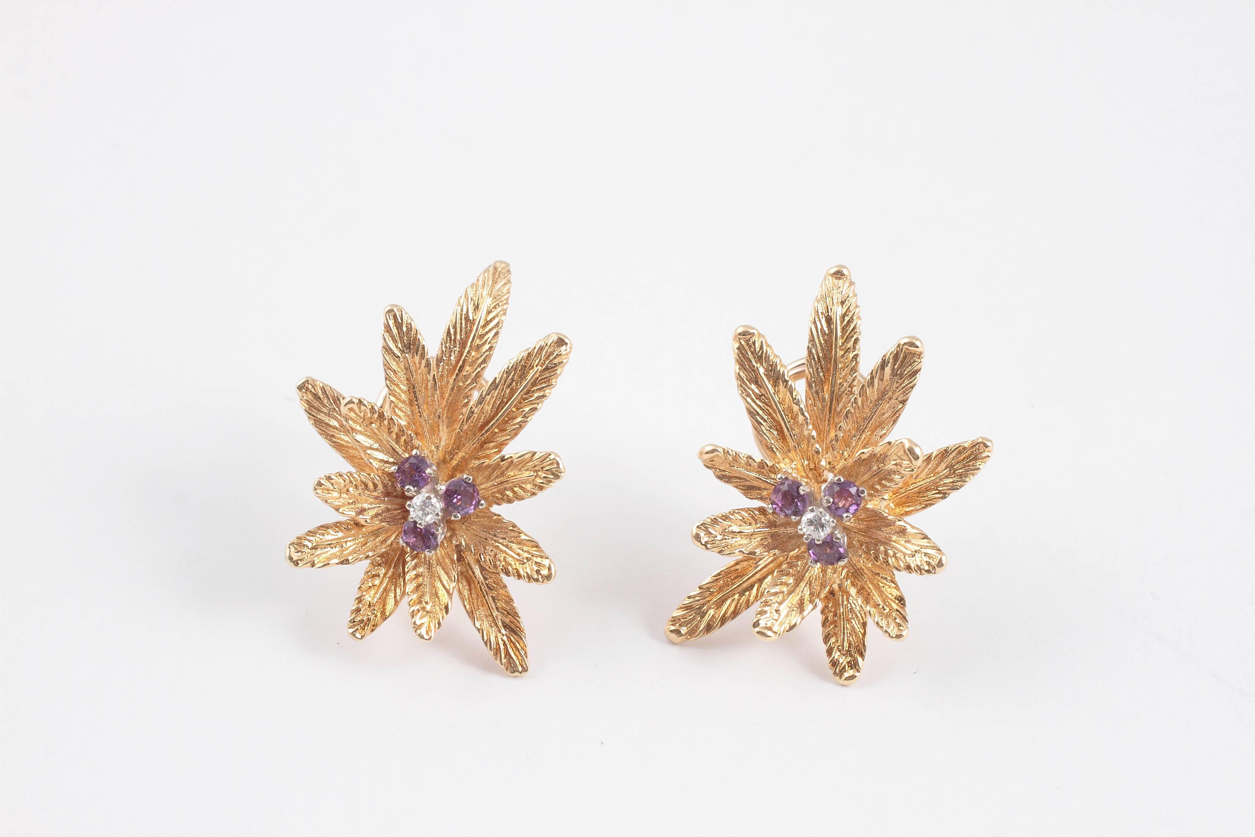A spray of leaves centered with a cluster of amethyst and diamond. Vintage and gold.  A great combination.  