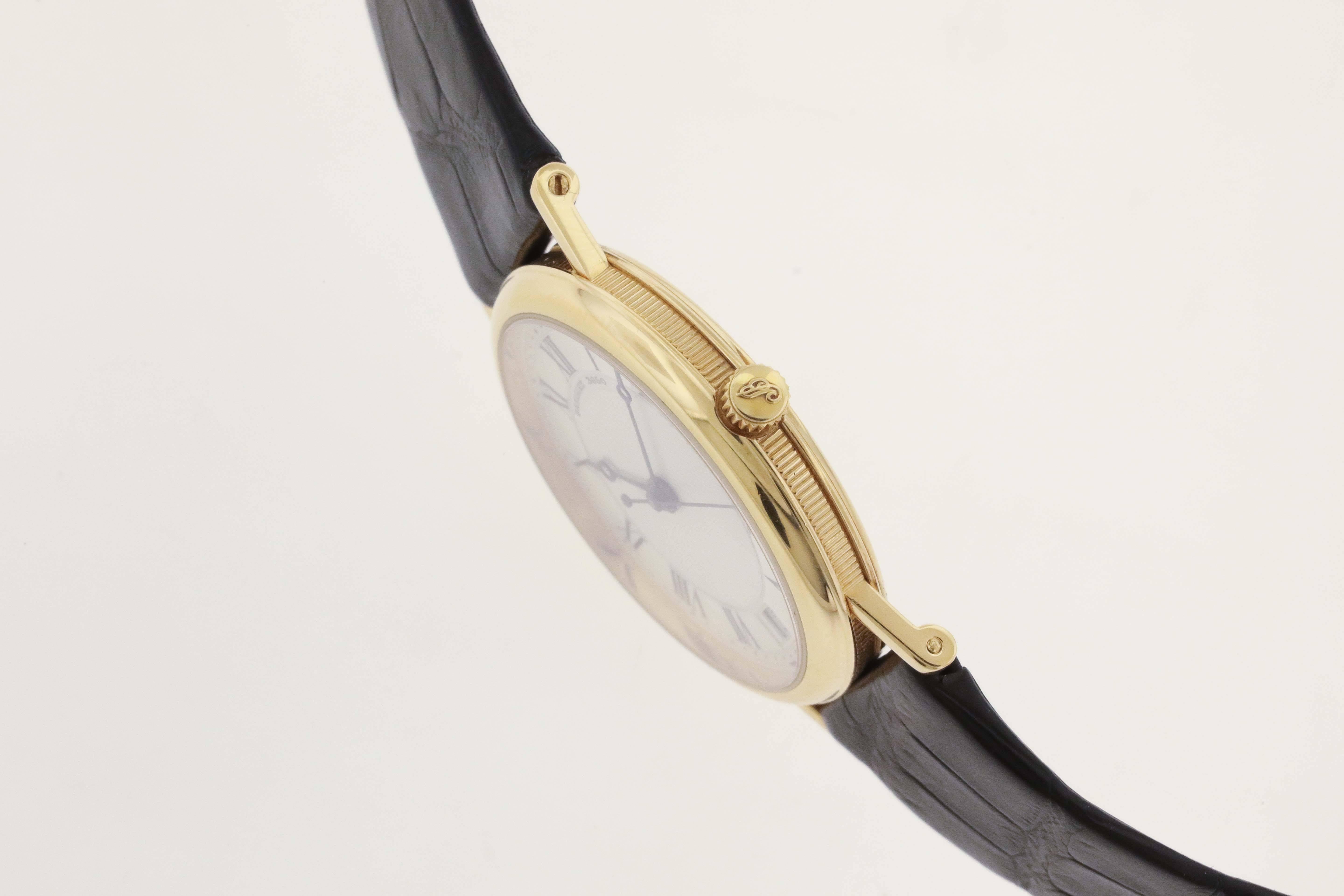 18K yellow gold Breguet Ref. 3980, circa 2010, was designed for men but its 32mm case makes it a perfect choice for women.  The case has an engraved back, reeded bezel, two-tone Breguet silvered dial with painted black Roman numerals on an outer