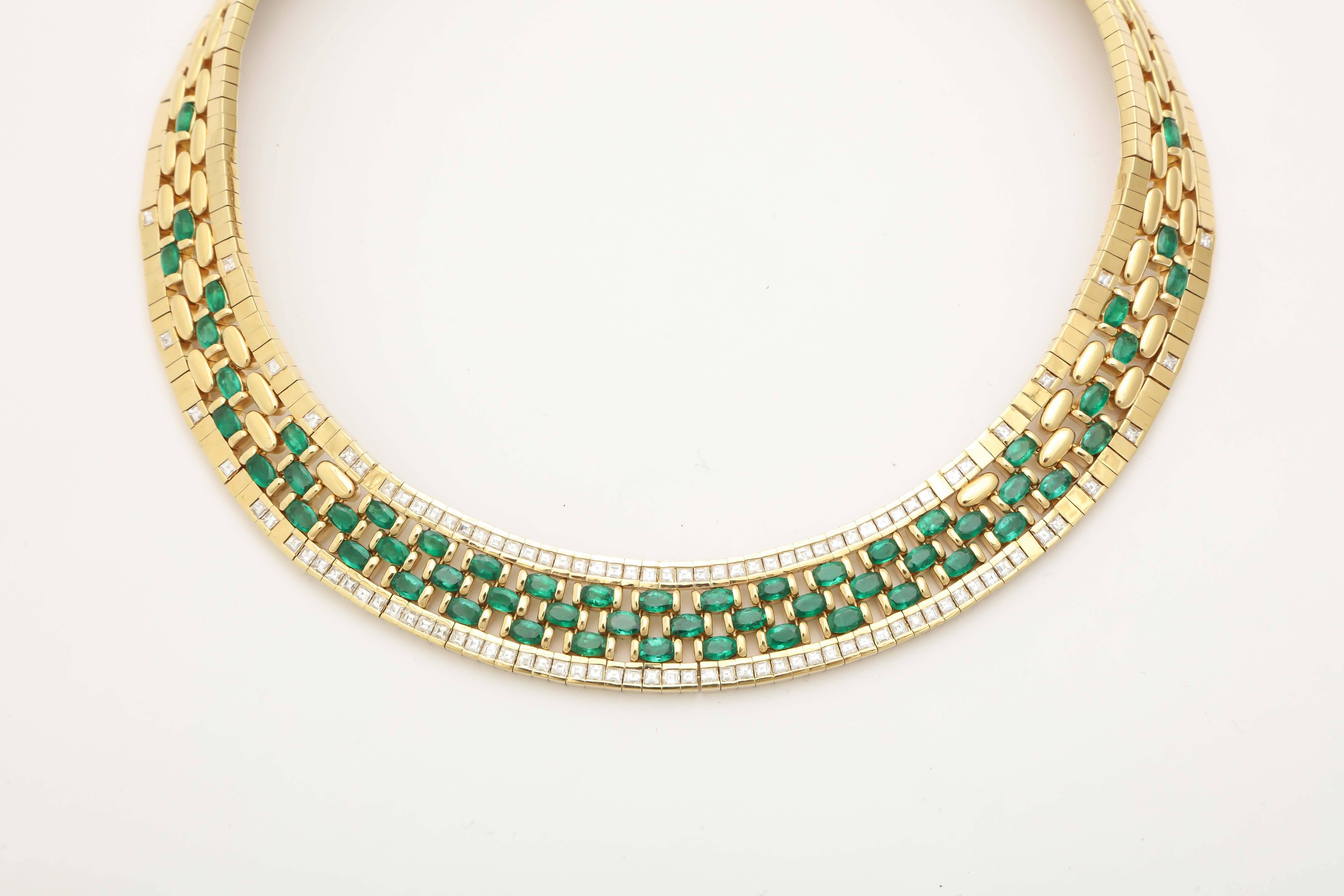 Elaborate 18kt Yellow Gold Necklace, highly polished,  with alternating Emeralds & Diamonds interwoven into a complex & colorful Tapestry.  99 square cut clean & white Diamonds weighing approximately a total of 7cts framing alternating Emerald &