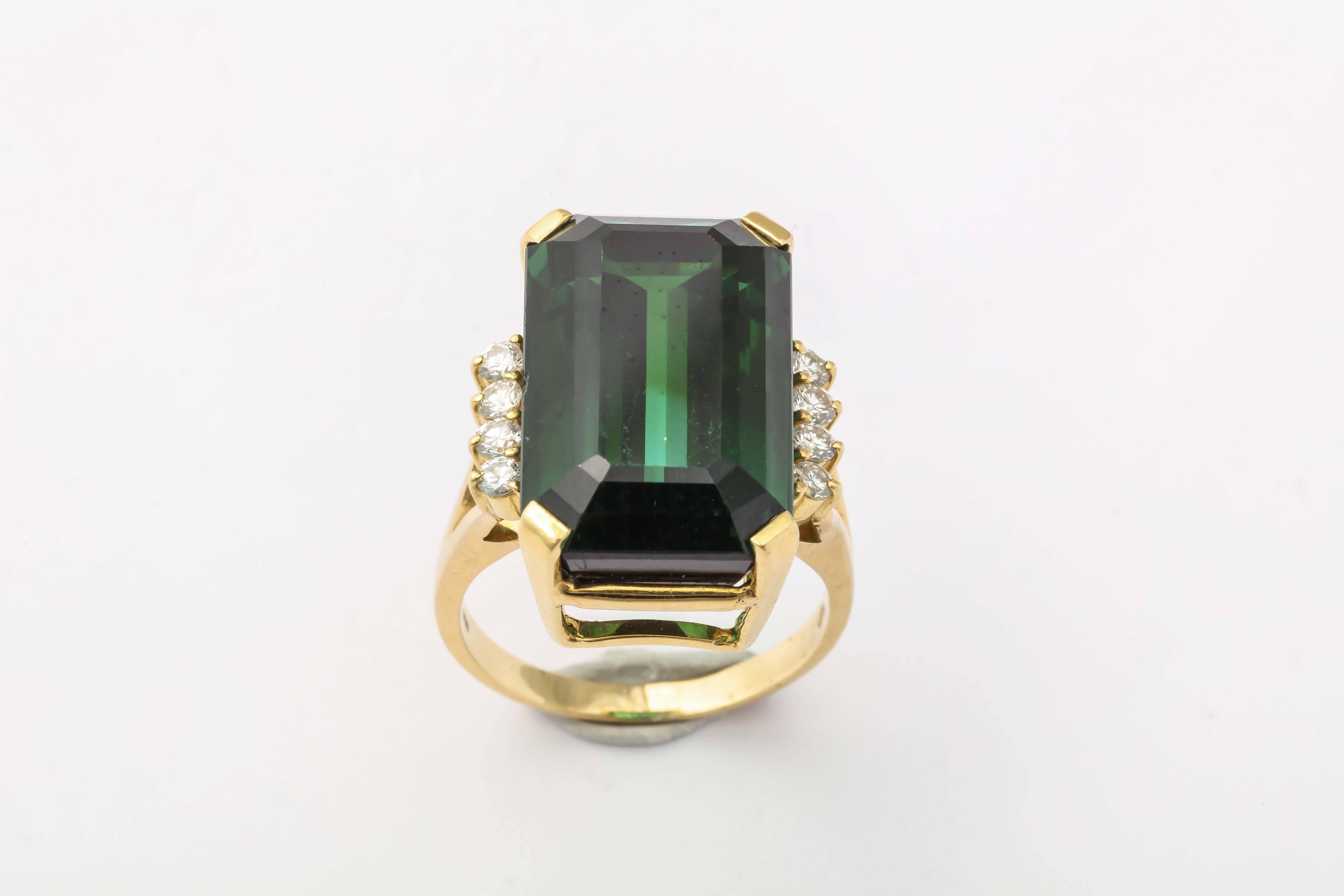 Superb & intense Green Tourmaline Ring set in a handmade 18kt Yellow Gold mounting  flanked by 4 full cut Diamonds on either side.  Measuring a size 8 - although it can be sized up or down. Signed Stern 
Tourmaline approximately 20 carats &