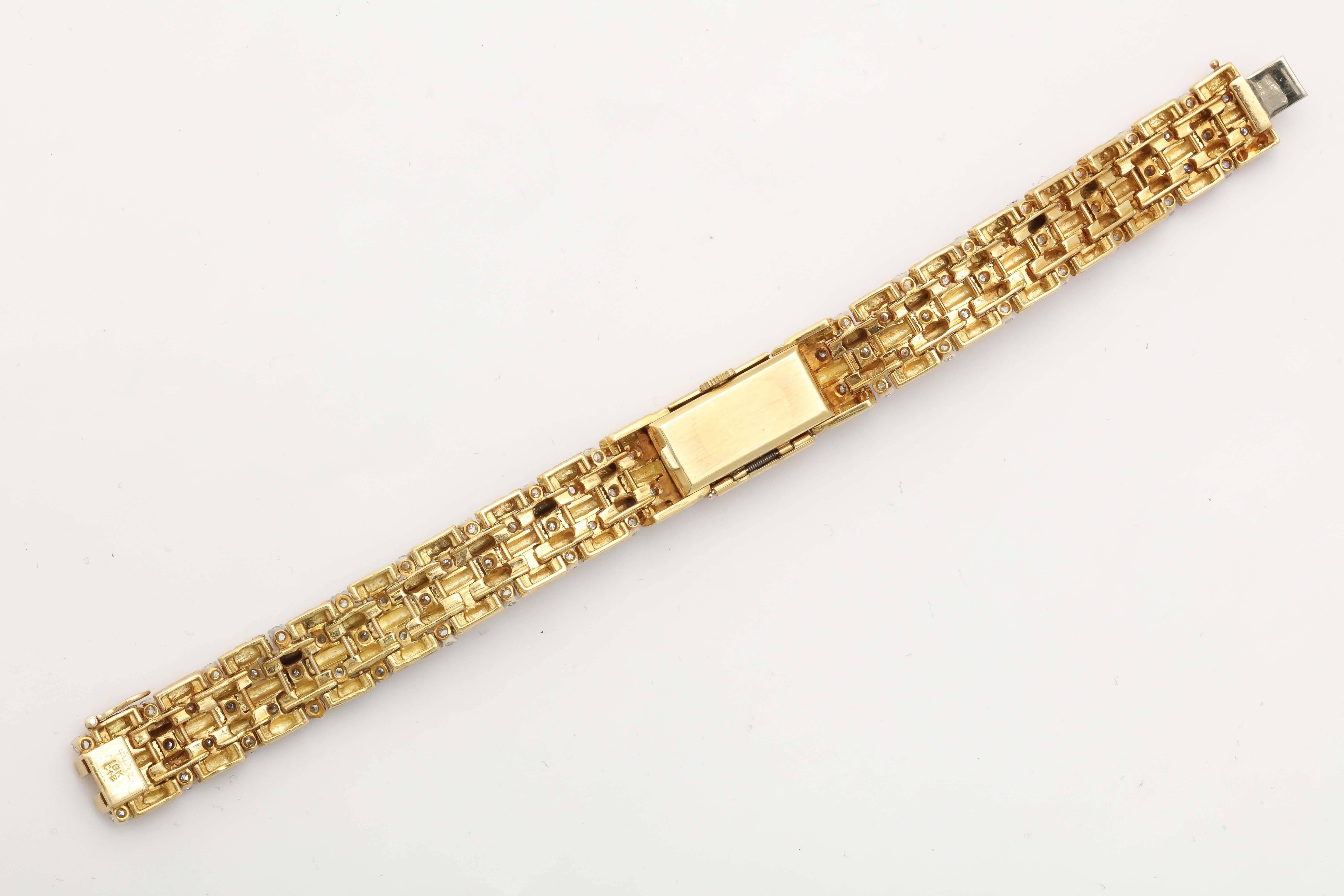 Stylish 18kt Yellow Gold watch Bracelet set with alternating rows of full cut clean and white Diamonds.  Watch face bearing Tiffany & Co. label and  baton markers.  Total of 96 Diamonds. totaling approximately 3 carats.
