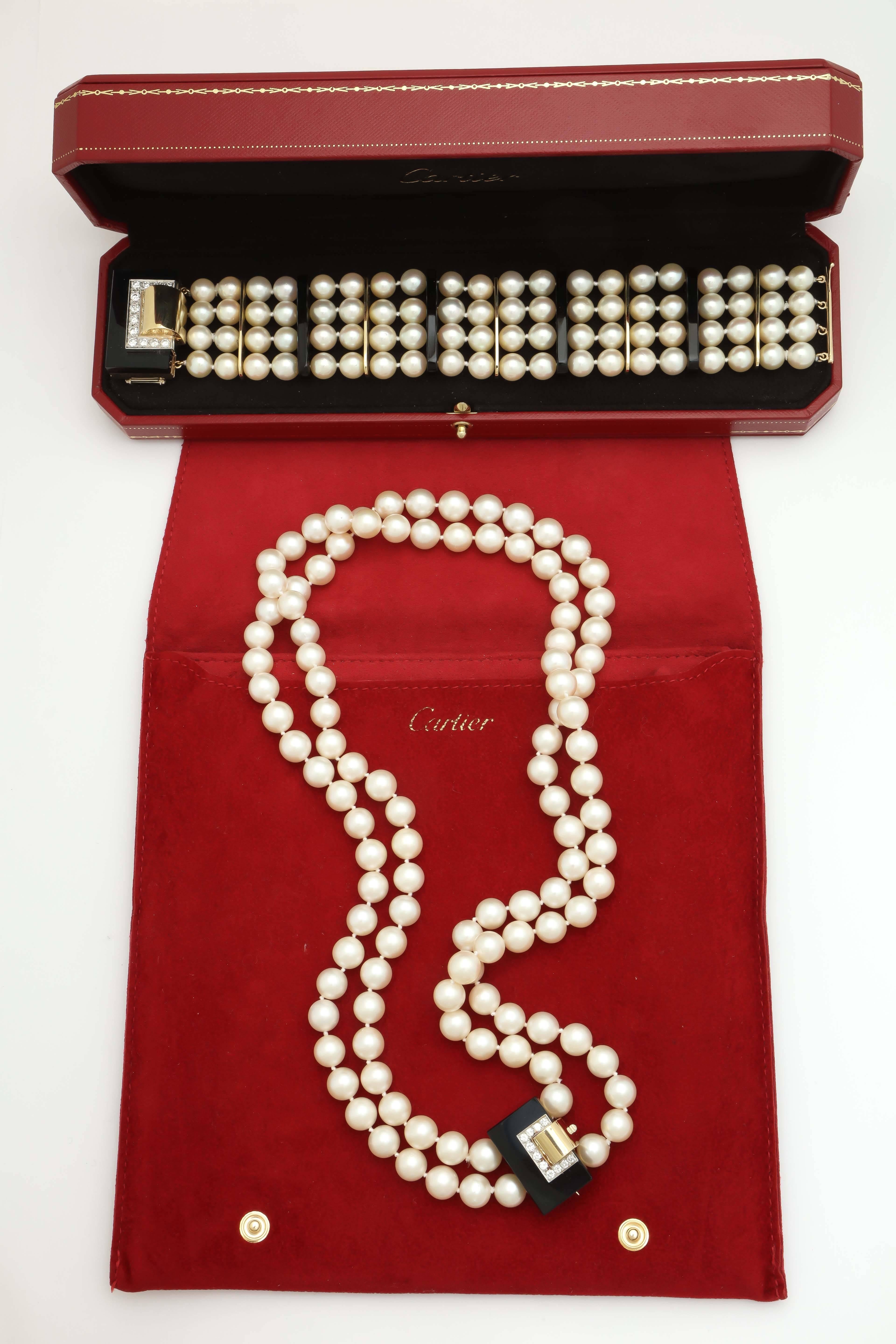 18kt Yellow Gold And Platinum Suite Consisting Of One Long Double Strand Of 10 MM Cultured Pearls Measuring 20 Inches In Length Featuring A Beautiful Onyx And Diamond And Platinum Geometric Clasp. Also Include In Ensemble Is a {4} Strand 8MM