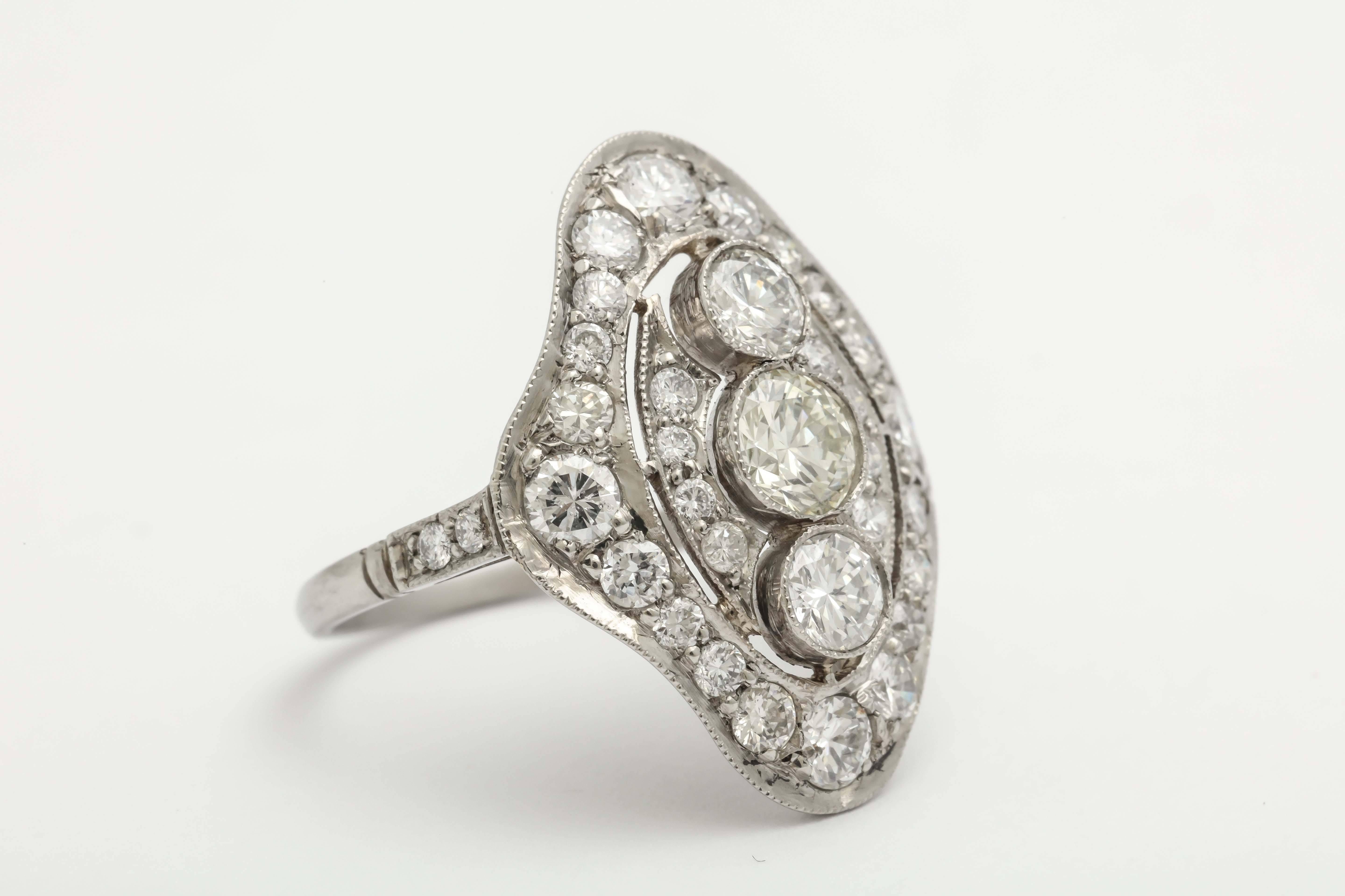 One Platinum & Diamond Cocktail Oblong Shaped Dinner Ring Centering [3] Vertical Bezel Set Diamonds Weighing Approximately .75 cts Total Weight And Surrounded By Numerous Antique cut Diamonds weighing Approximately 1.25 Carats. Total Weight Of