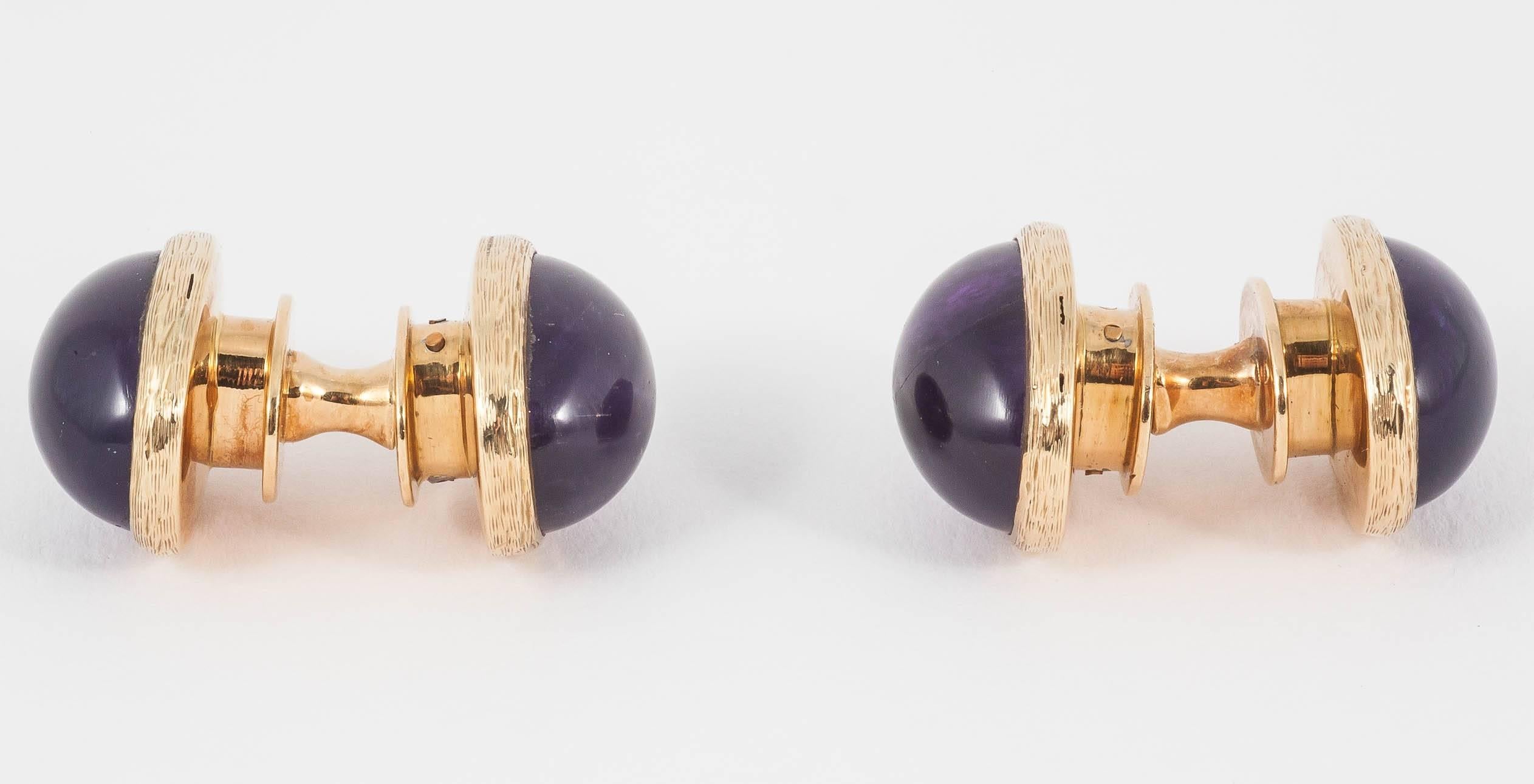 A heavy quality pair of large cabochon shaped amethyst double sided cufflinks mounted in 18 carat yellow gold. Snap-in design where the links join together very effectively in a suction fit. Made by S J Phillips 1982 (London).
Measures 20mm in