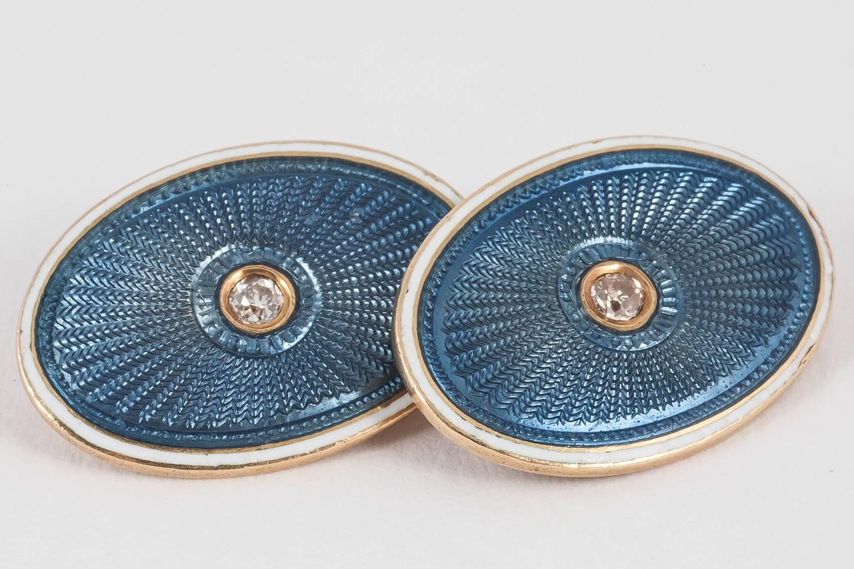 Fine pair of guilloche,blue enamel cufflinks of sunburst design with a diamond centre,and white enamel border,mounte in 18ct yellow gold,English, c 1900-10