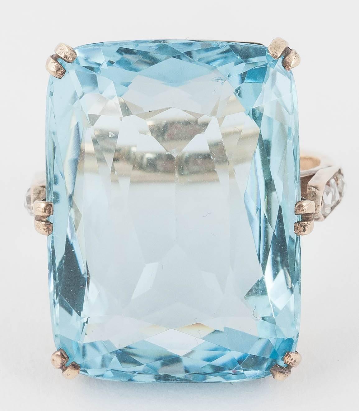 This stunning ring is set in 14ct Gold with 3 rose cut Diamonds on each shoulder.
The central Aquamarine is natural and weighs over 35cts