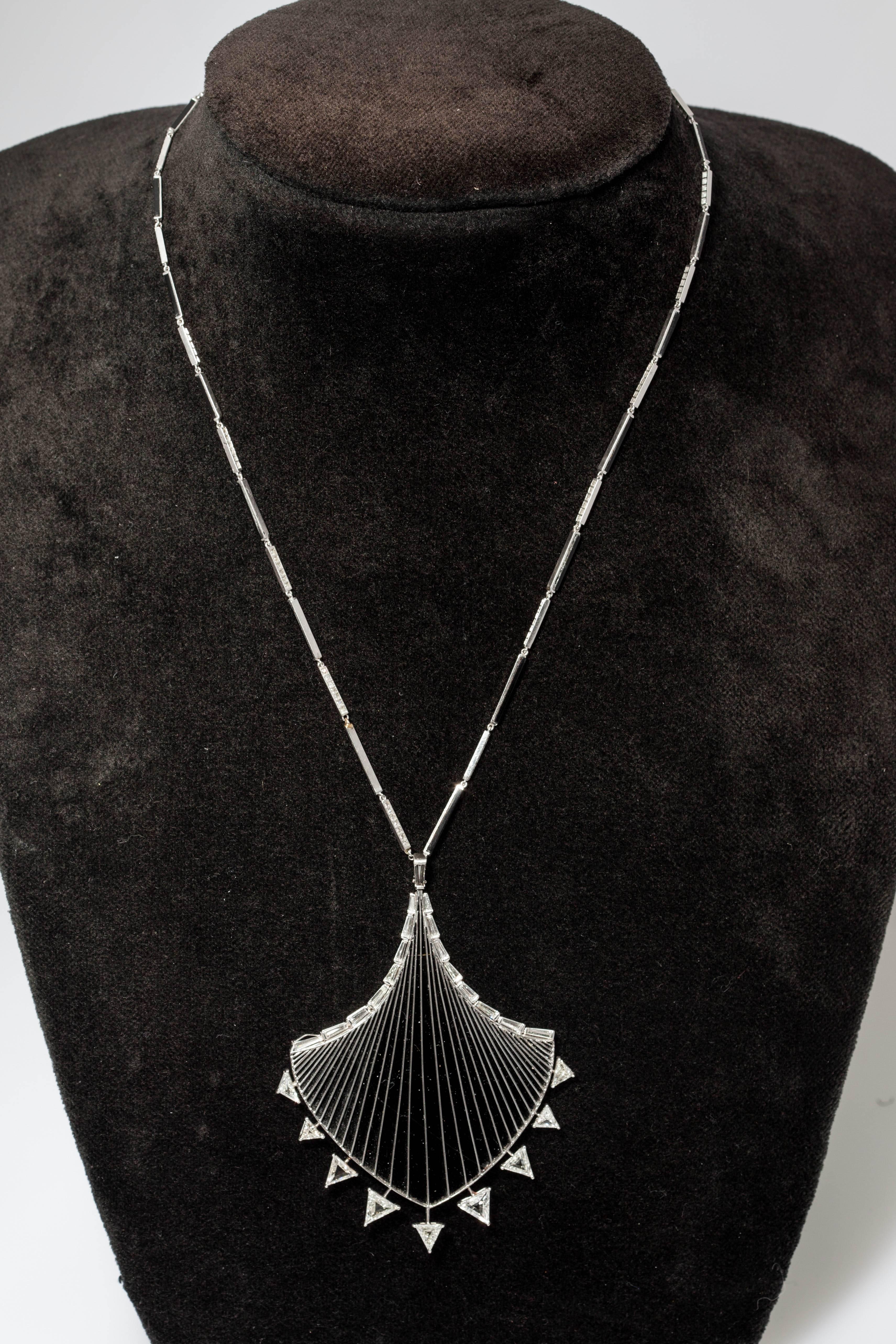 Ein zartes und sorgfältig gearbeitetes Set bestehend aus Halskette und Ohranhängern, der Hauptteil aus Onyx, getragen von einer Platinstruktur, an der feine Diamanten im Dreiecksschliff befestigt sind, die Kette, die die Halskette trägt, ebenfalls