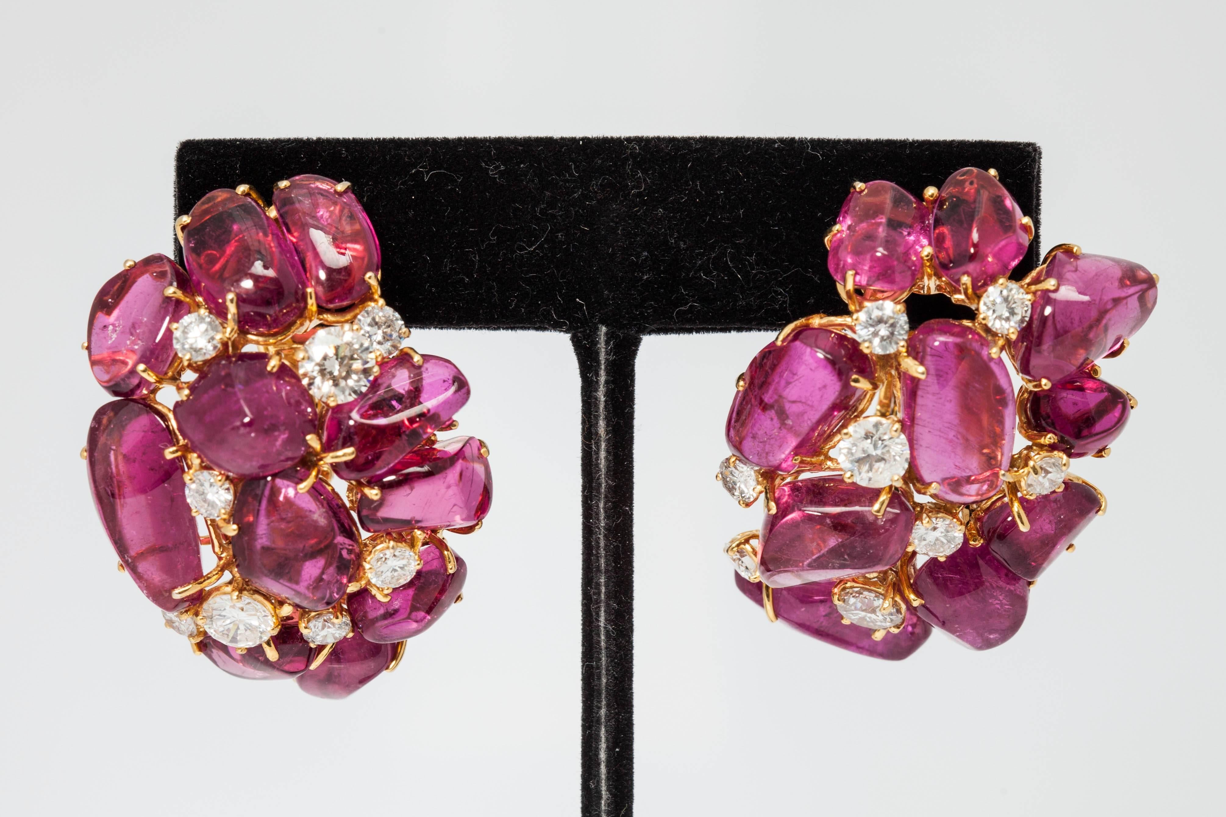 A chic and bold pair of 18kt yellow gold, tourmaline and diamond ear clips. Circa 1975. Diamond weight: Approximately 6cts.