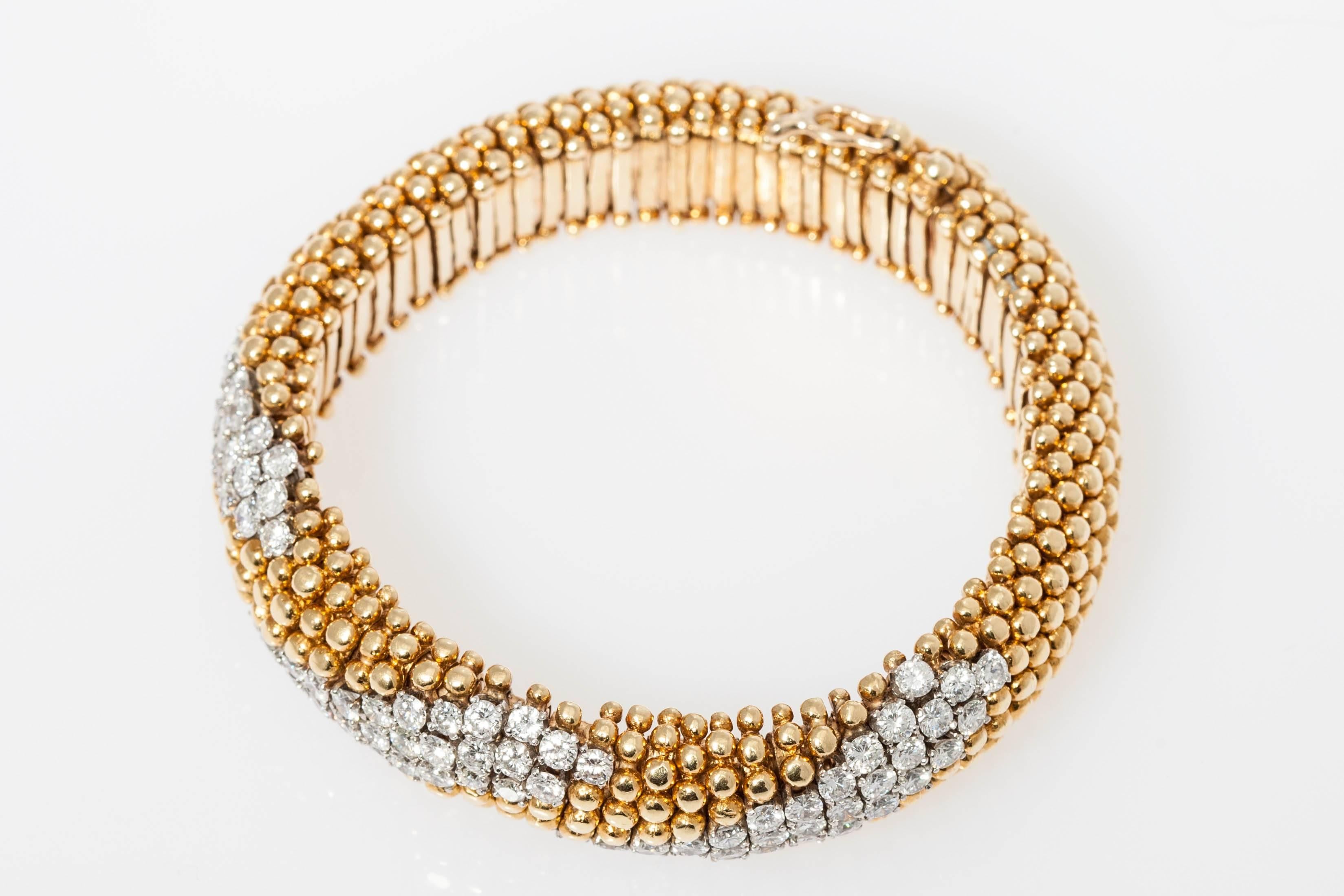 A chic pair of cous-cous design 18kt yellow gold and fine quality brilliant diamonds bracelets. Circa 1970. Diamond weight: Approximately 20cts total (10cts each). 

