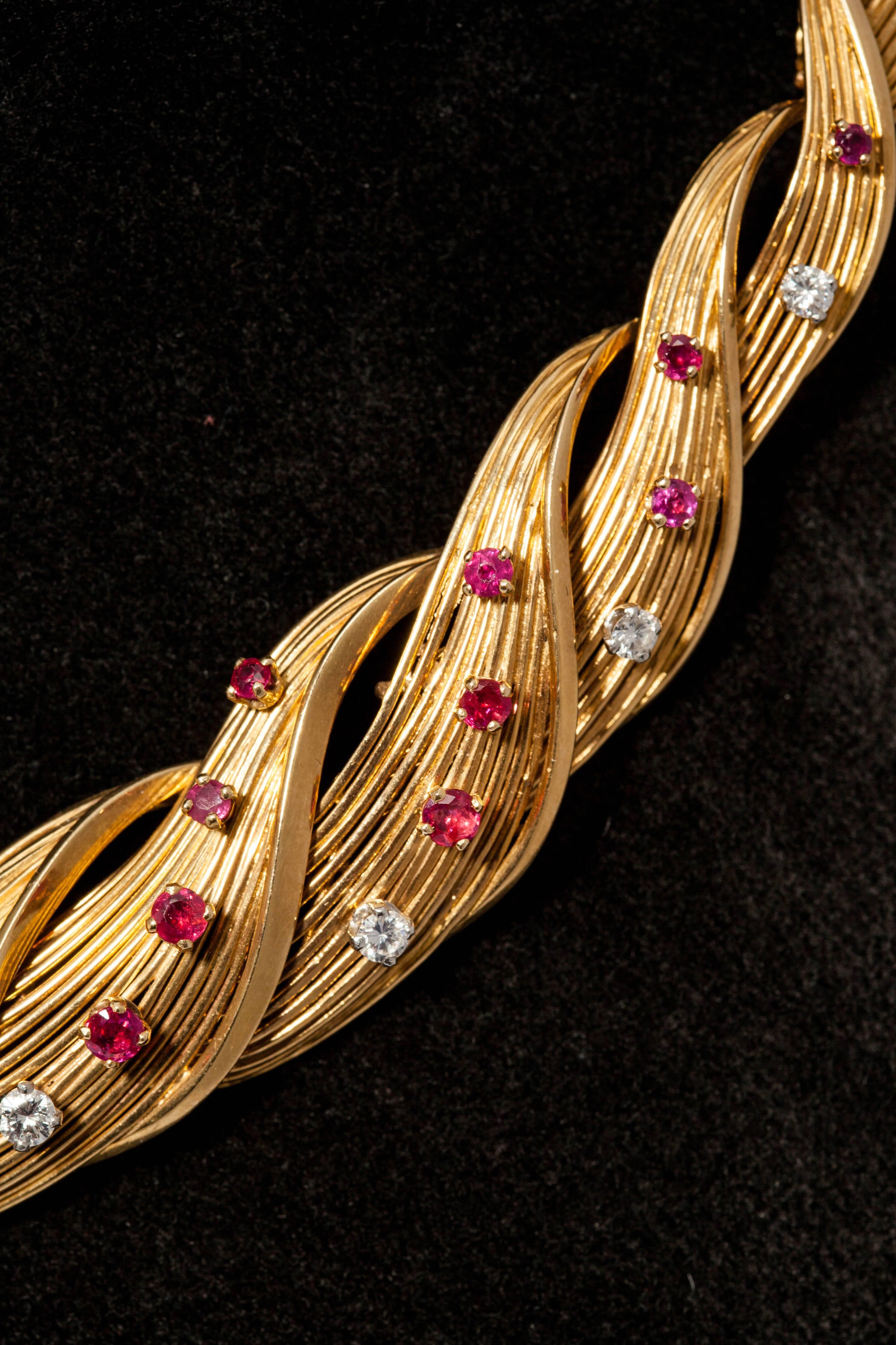 A chic set comprised of necklace and bracelet, in woven 18kt yellow gold, highlighted by round cut diamonds and rubies, by esteemed French jeweler Mellerio. Made in Paris, France, circa 1950.