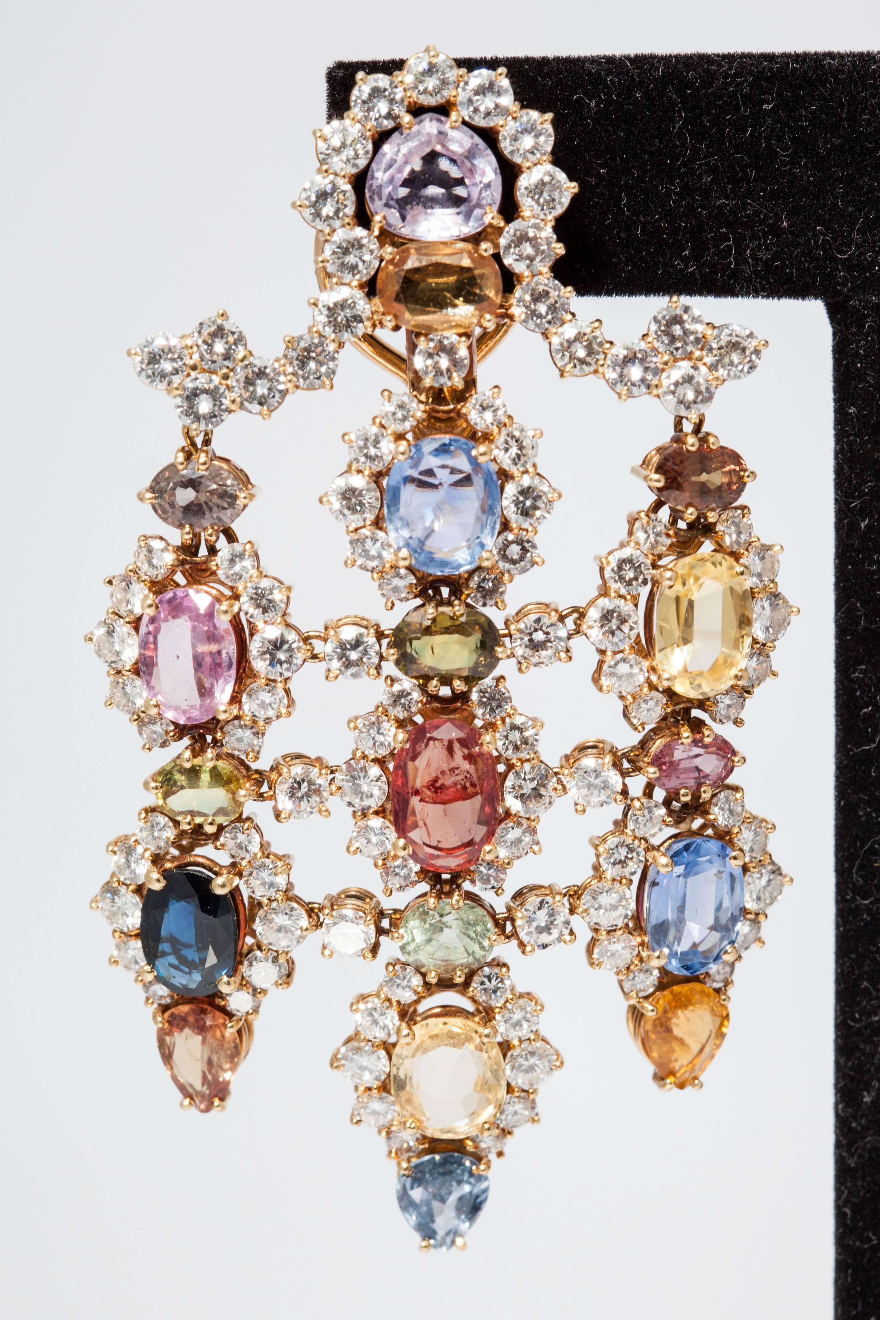 A spectacular pair of chandelier ear pendants, presenting several natural multicolor sapphires and diamonds on a finely crafted 18kt yellow gold mounting, circa 1965. 