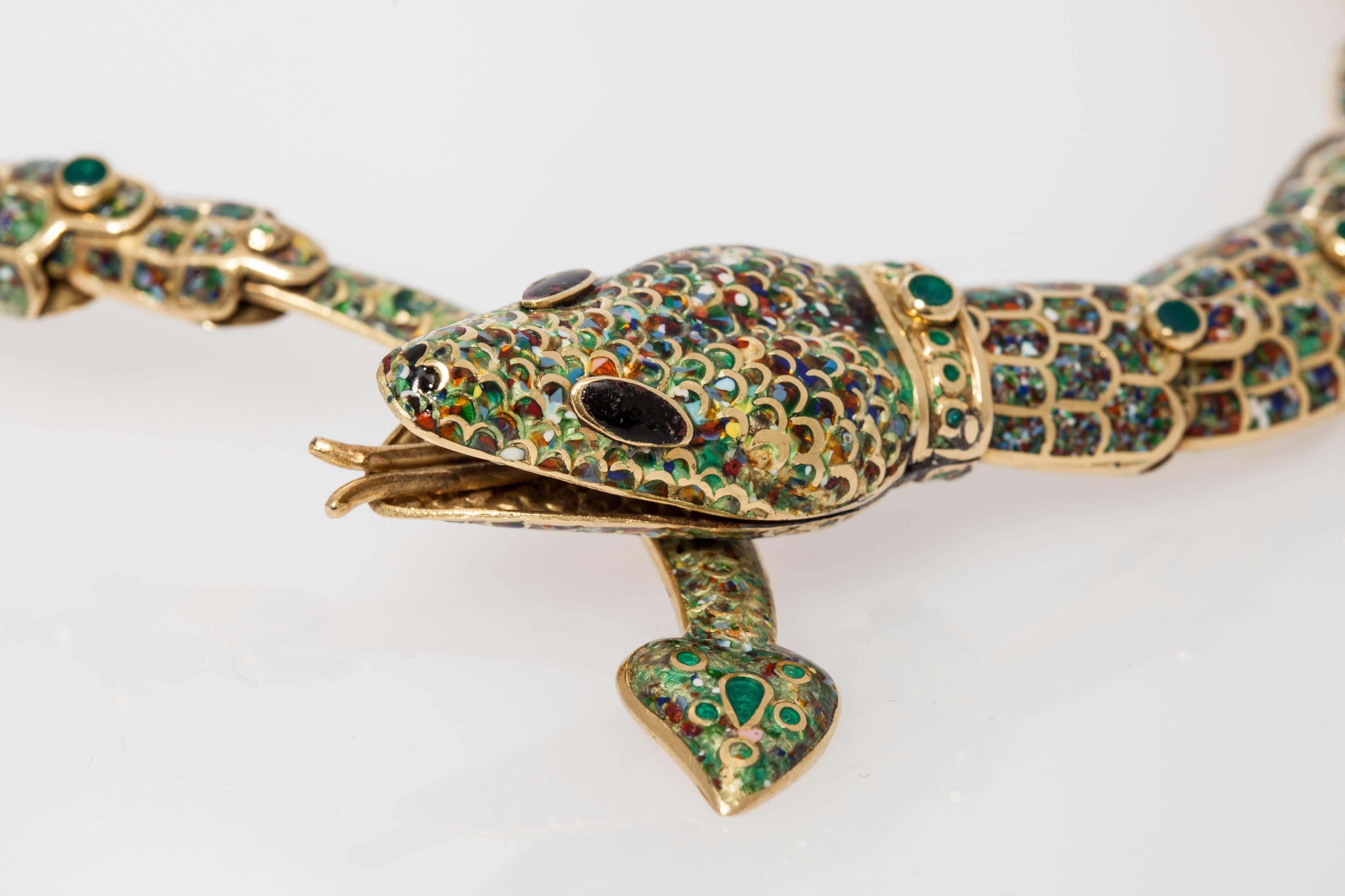 A peculiar snake set comprising a bracelet and a necklace, in 18kt yellow gold and fine enameling. Made in Taxco, Mexico, circa 1950. 