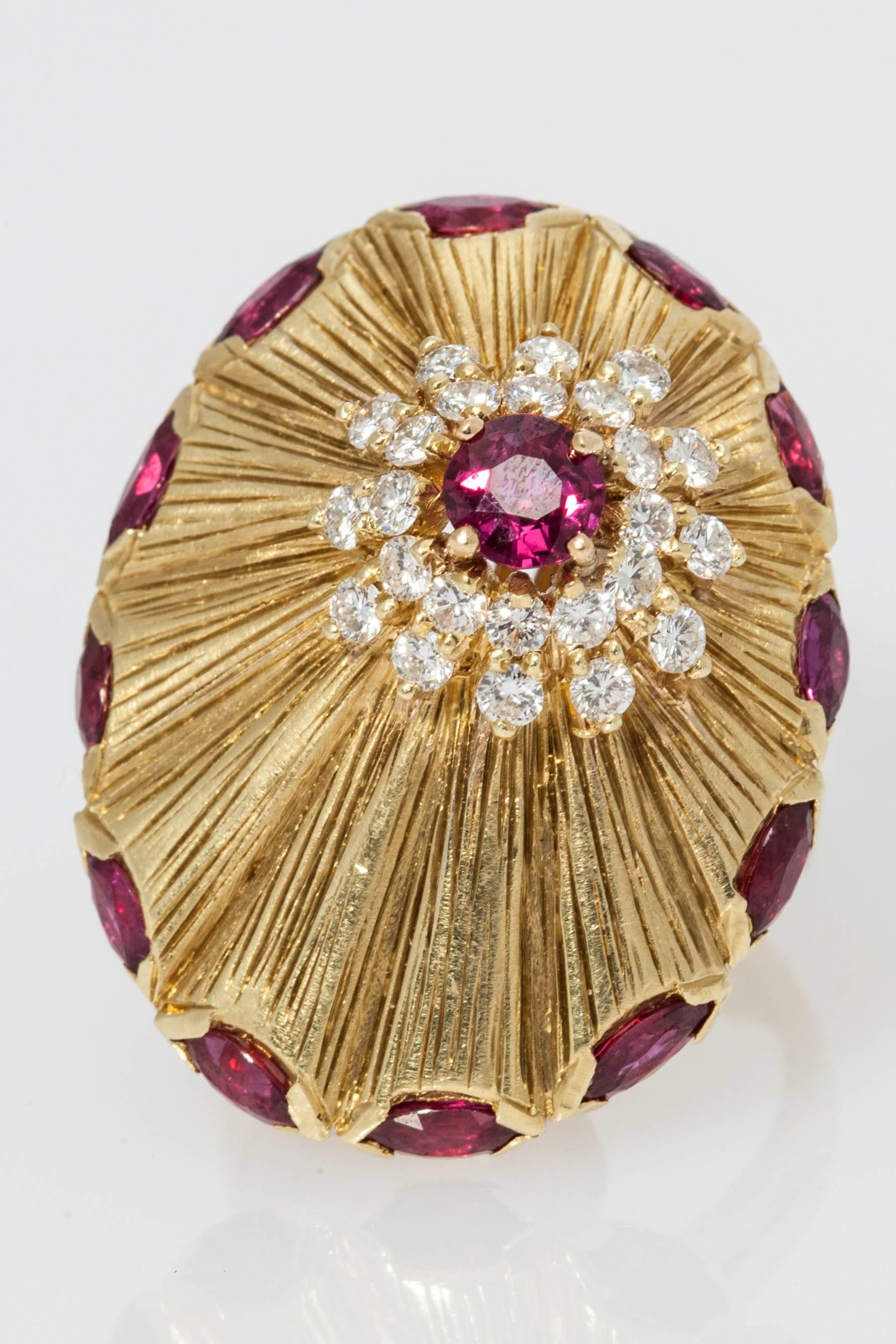 A whimsical and large cocktail ring made in 18kt yellow gold, resembling the shape of a Star-Ship, impeccably crafted highlighted hexagonal cut rubies around its side, as well as on its top (asymmetrically), further enriched with smaller brilliant