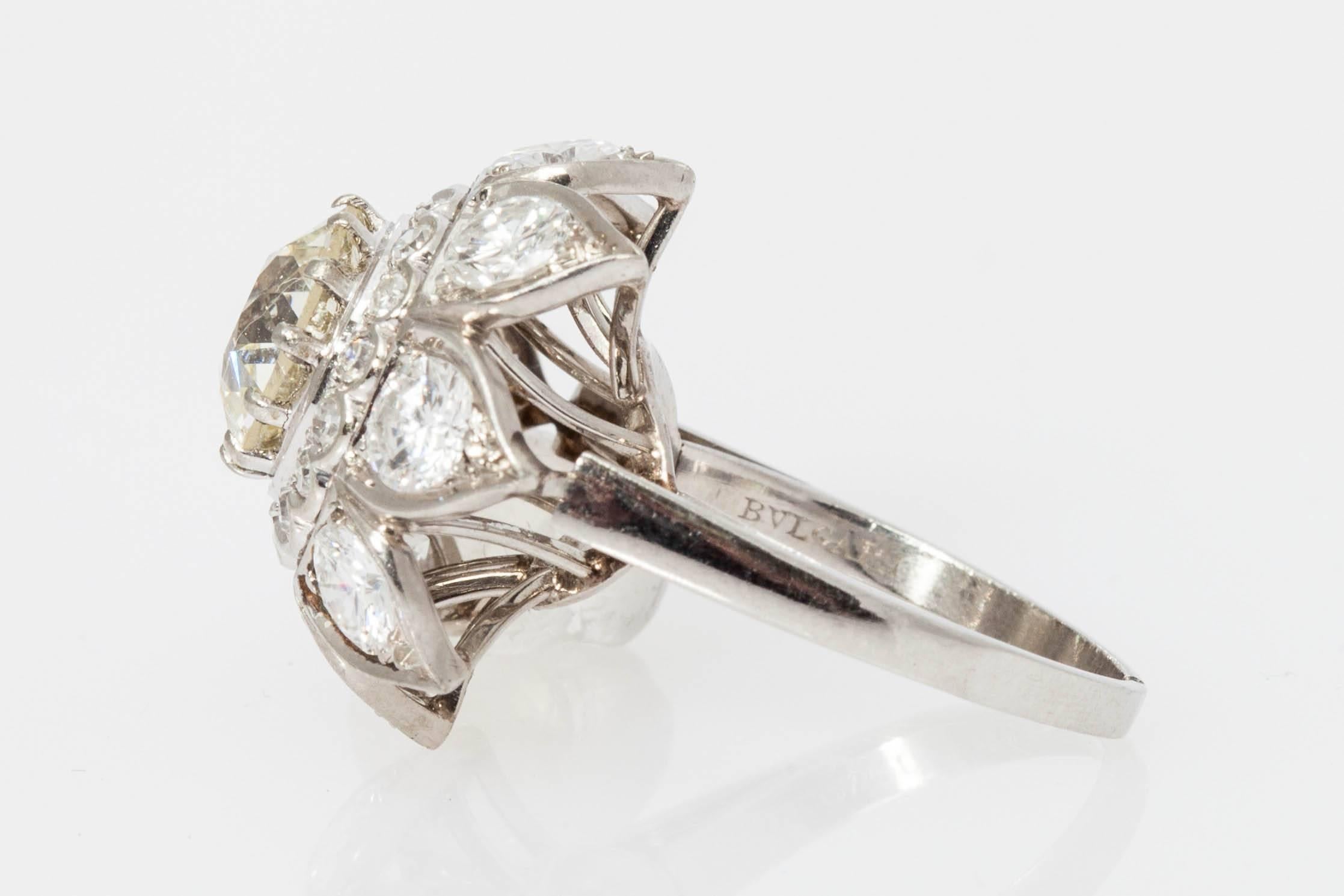 A white gold an diamond ring by BULGARI, showcasing a 3.16ct O-P Colour VS1 Clarity stone (Cisgem Certificate), on a floral shaped mounting, the latter enriched by approximately 3cts of fine brilliant cut diamonds. Made in Italy, circa 1960.