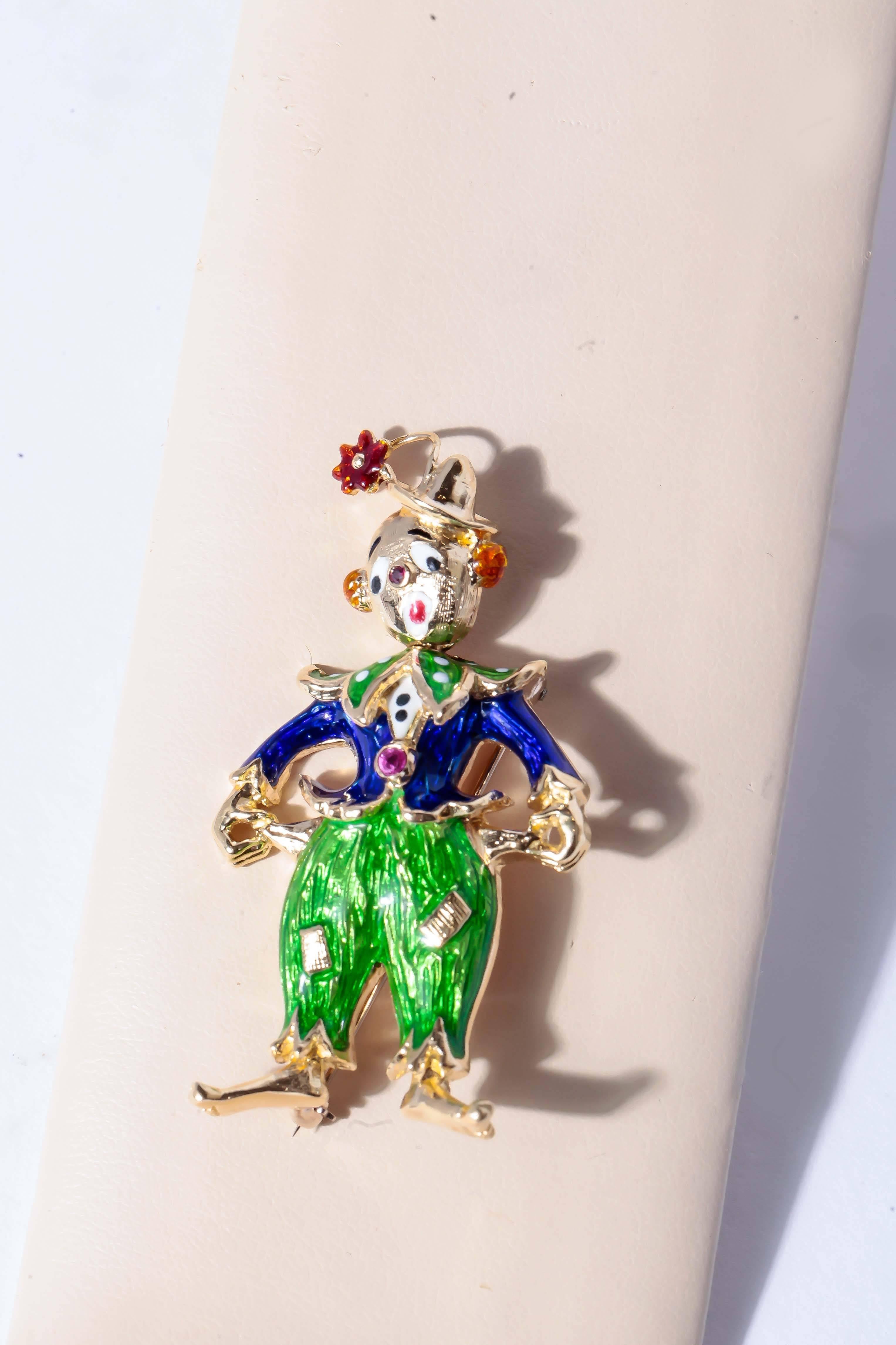 Clown Brooch enameled on 18K yellow gold.  Our happy clown goes from
happy to sad with a turn of his head.  With bezel set ruby accents.  Our clown weighs in at 12.7 penny weights.  