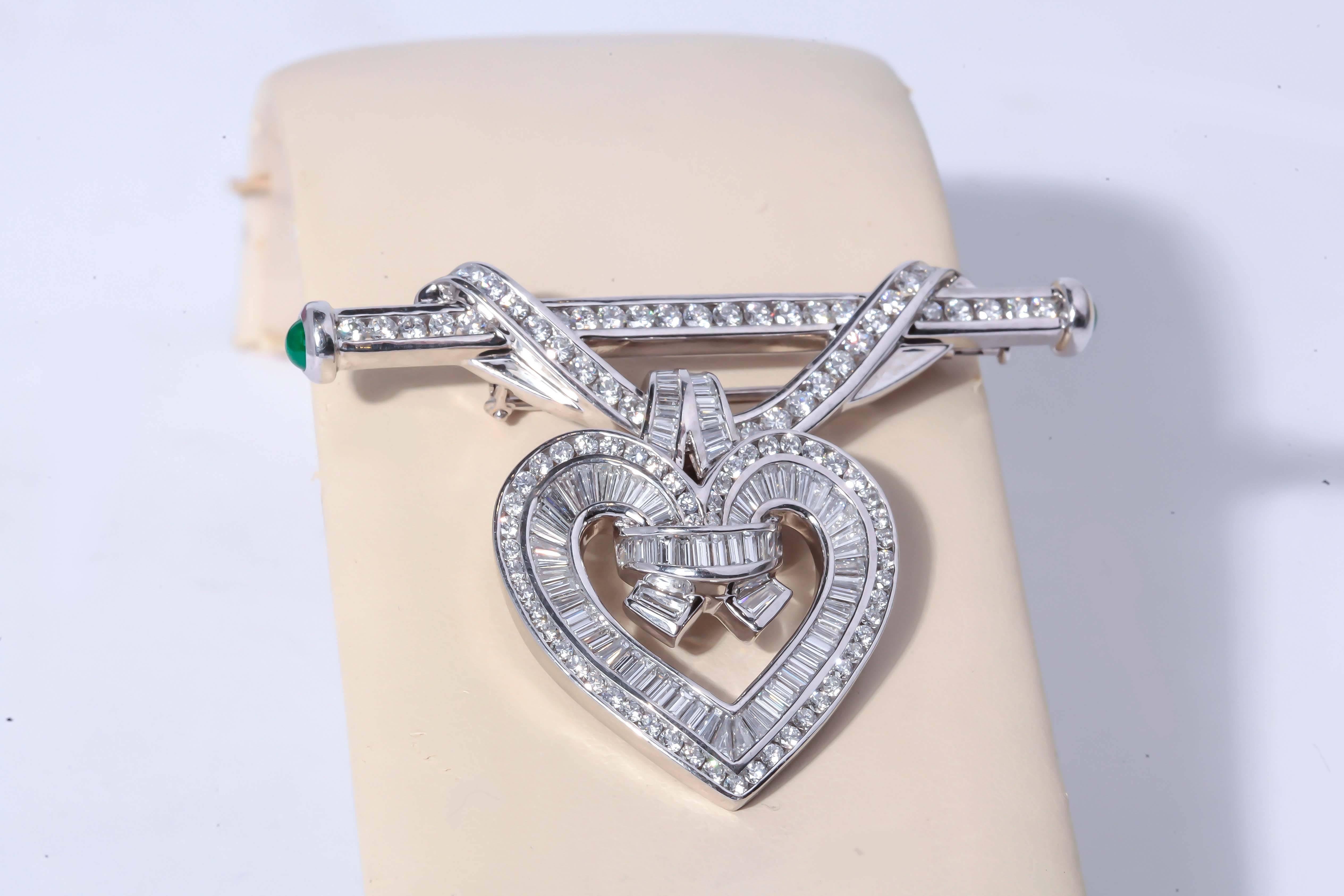 This brooch by Charles Krypell is set with approximately 5.91ct tw, round brilliant cut diamonds and baguette cut. The bar style brooch features a swag motif, and a detachable diamond heart, enhancer style pendant. The bar style brooch is finished
