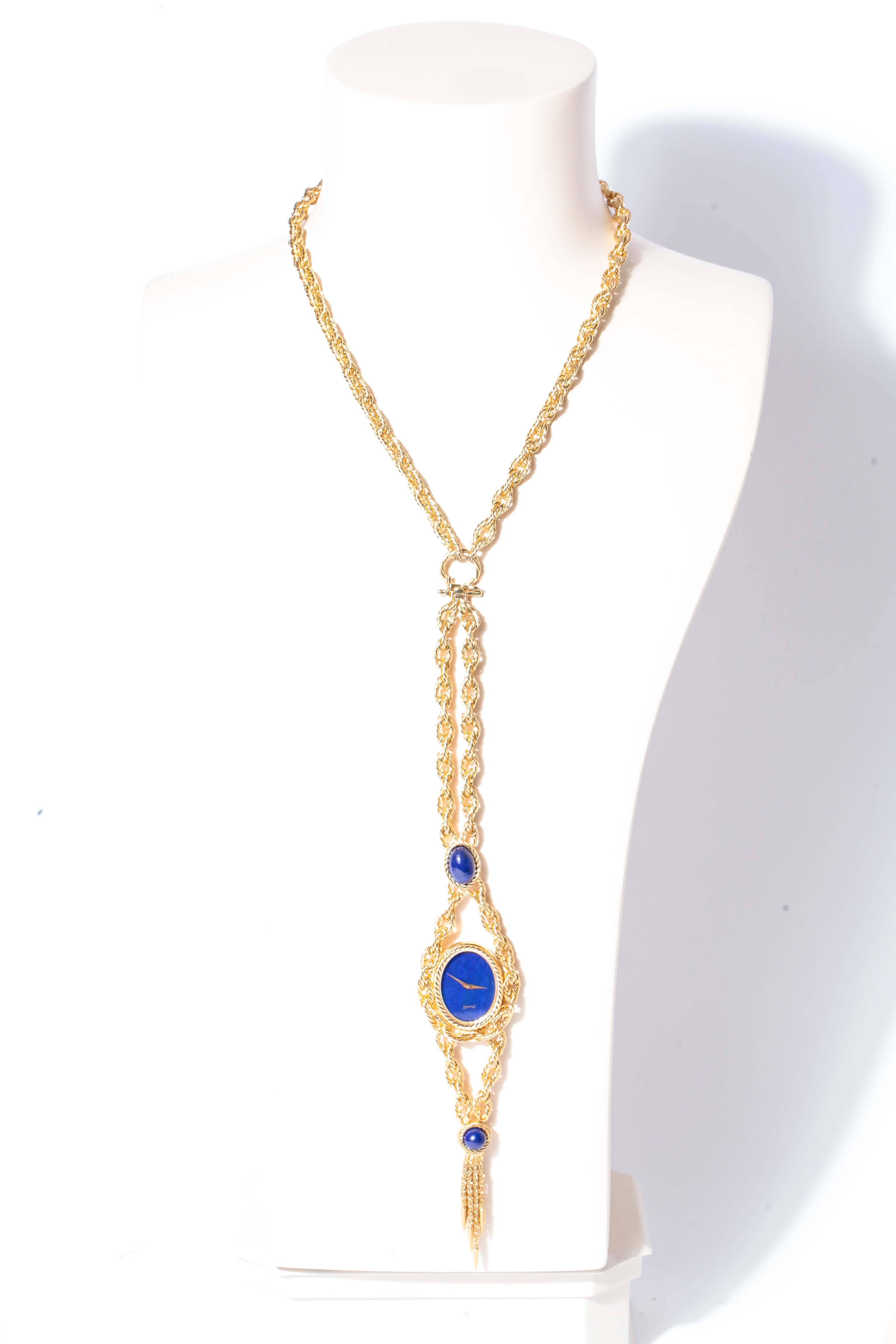 Piaget 18KY  Lapis Lazuli necklace/ bracelet watch. Watch has a textured bezel and an oval Lapis Lazuli dial and two lapis cabochons on bracelet. Chain is 18KY texture oval links measuring 24 inches in length. Wristwatch measures approximately
