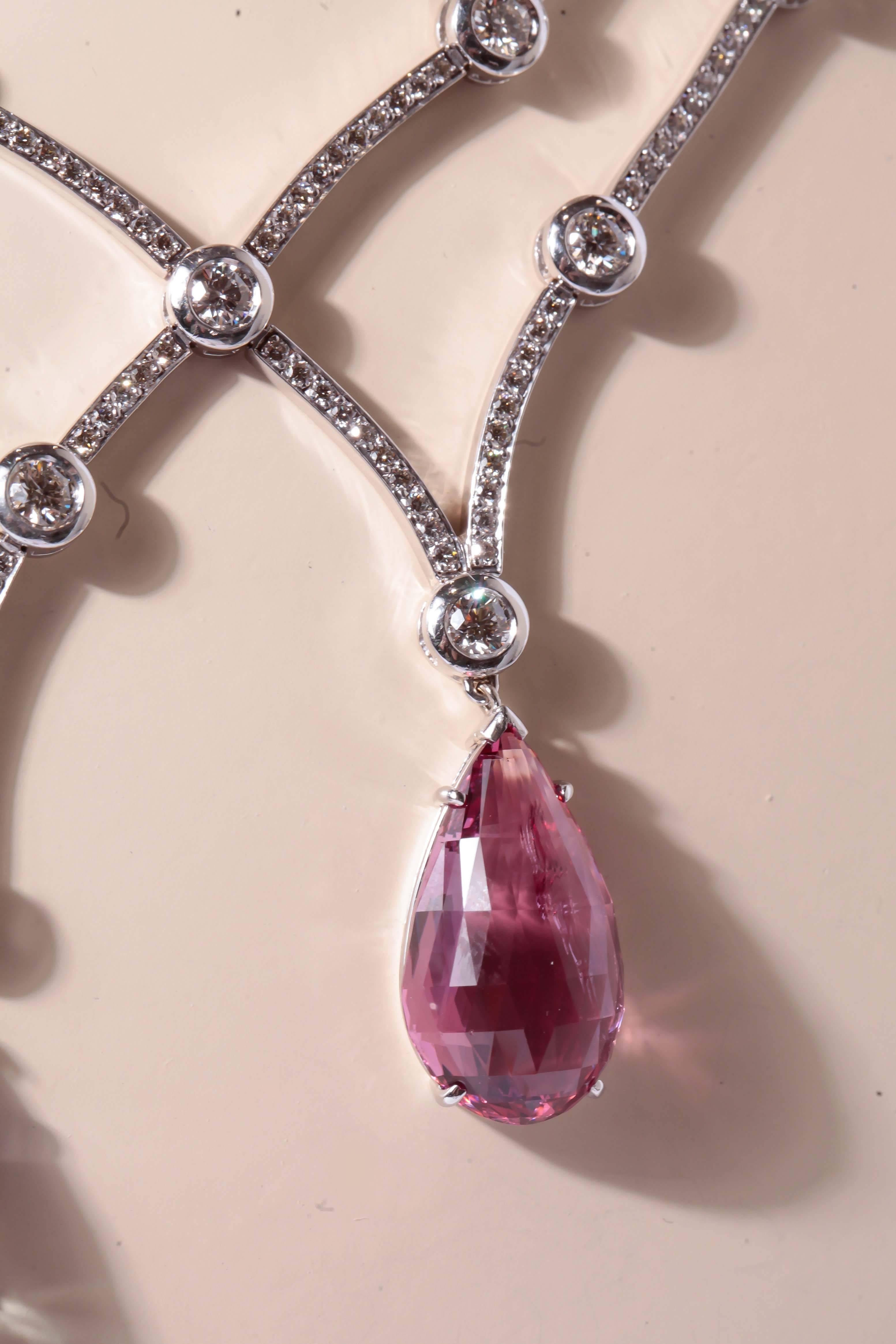Designer Neil Joseph necklace appointed with  8.14 carats total weight of VS2 clarity, H color, bezel set diamonds.   This necklace also consists of one
pear shape faceted blue saphire and one pink pear shaped spinel. The total weight for the two