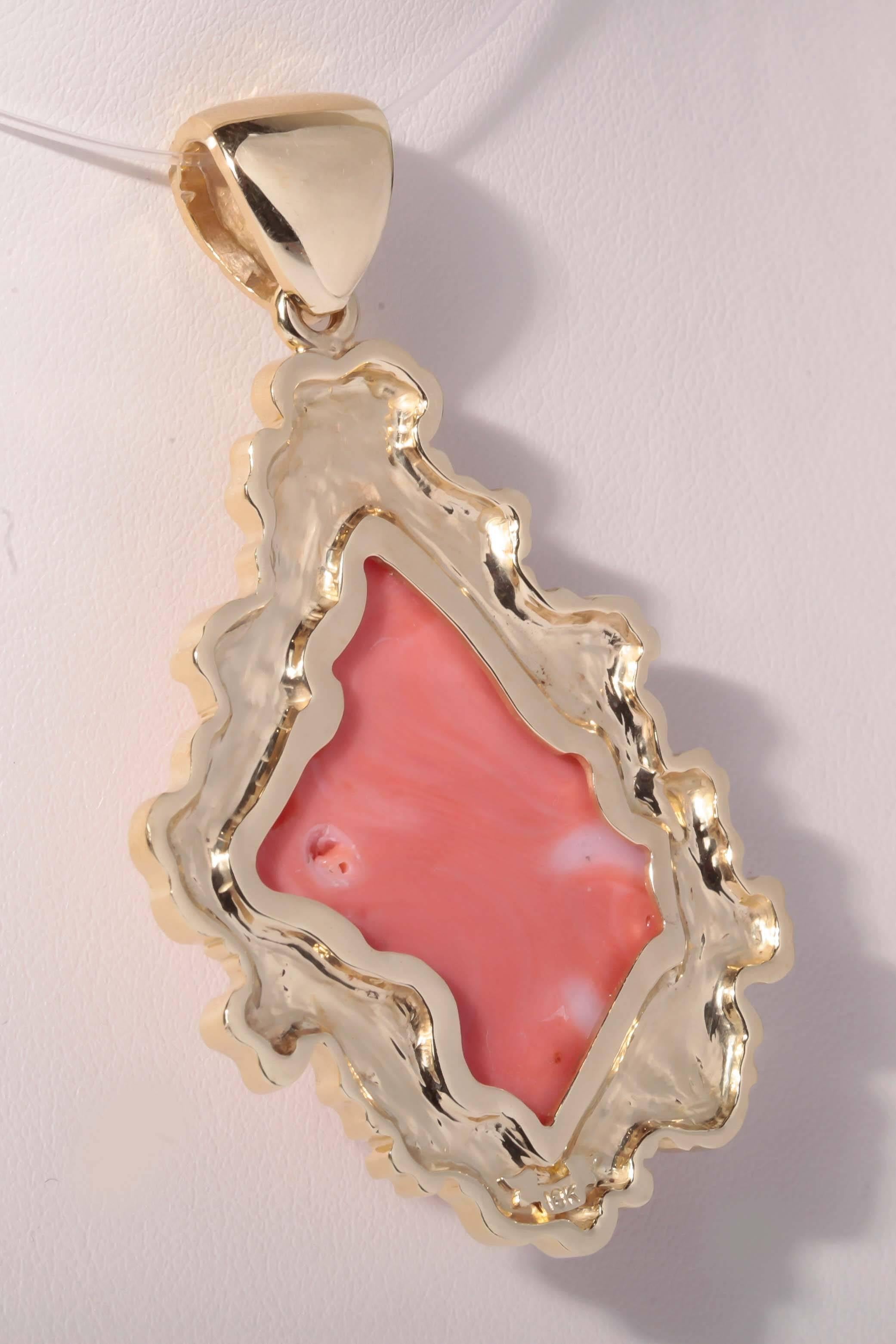 
This large hinged bail, one of a kind 18K yellow gold and carved coral pendant was custom designed for the Coral Cameo. The whimsical mane like extension of the cameo's flowing hair, was created in our shop.  