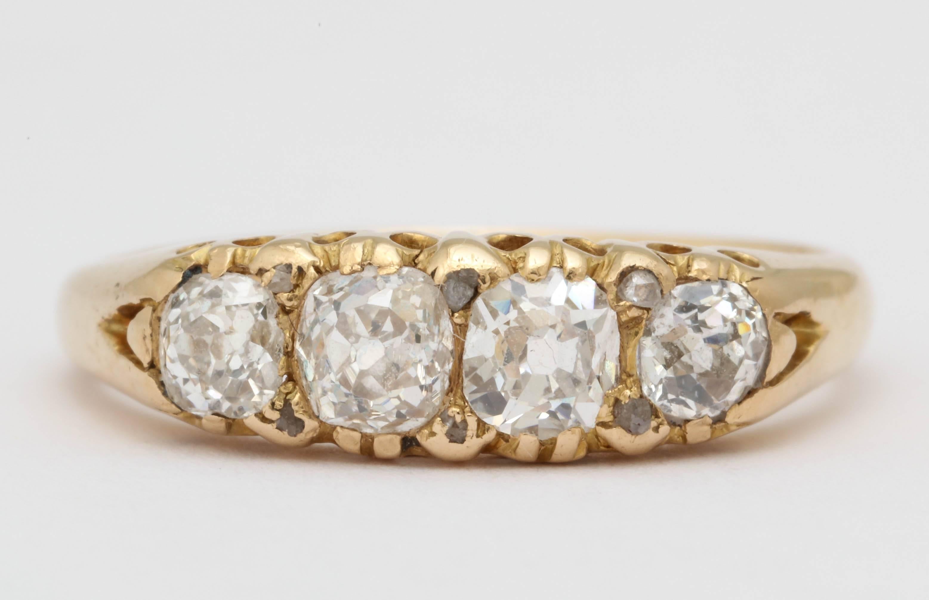Beautiful chunky old mine cut diamonds are set in 18K yellow gold. Six small rose cut diamonds are set between them. Total carat weight approximately .70. Worn 