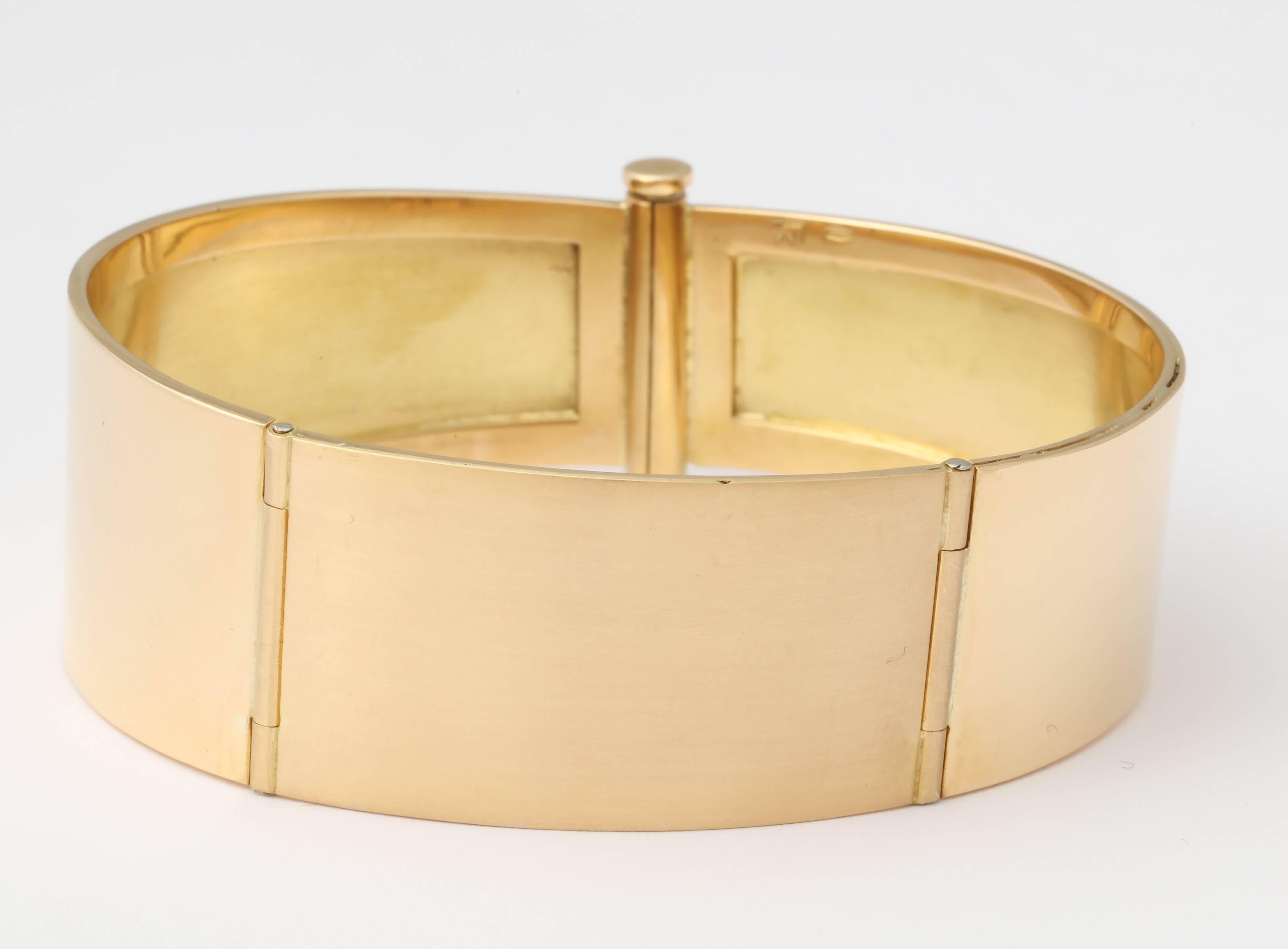 18 kt Yellow Gold - polished sides and center matte Bangle.  Signed LM and marked 750.  Very unusual Barrel closing.  Center is two different widths on a slightly graded width.  One of a kind.  