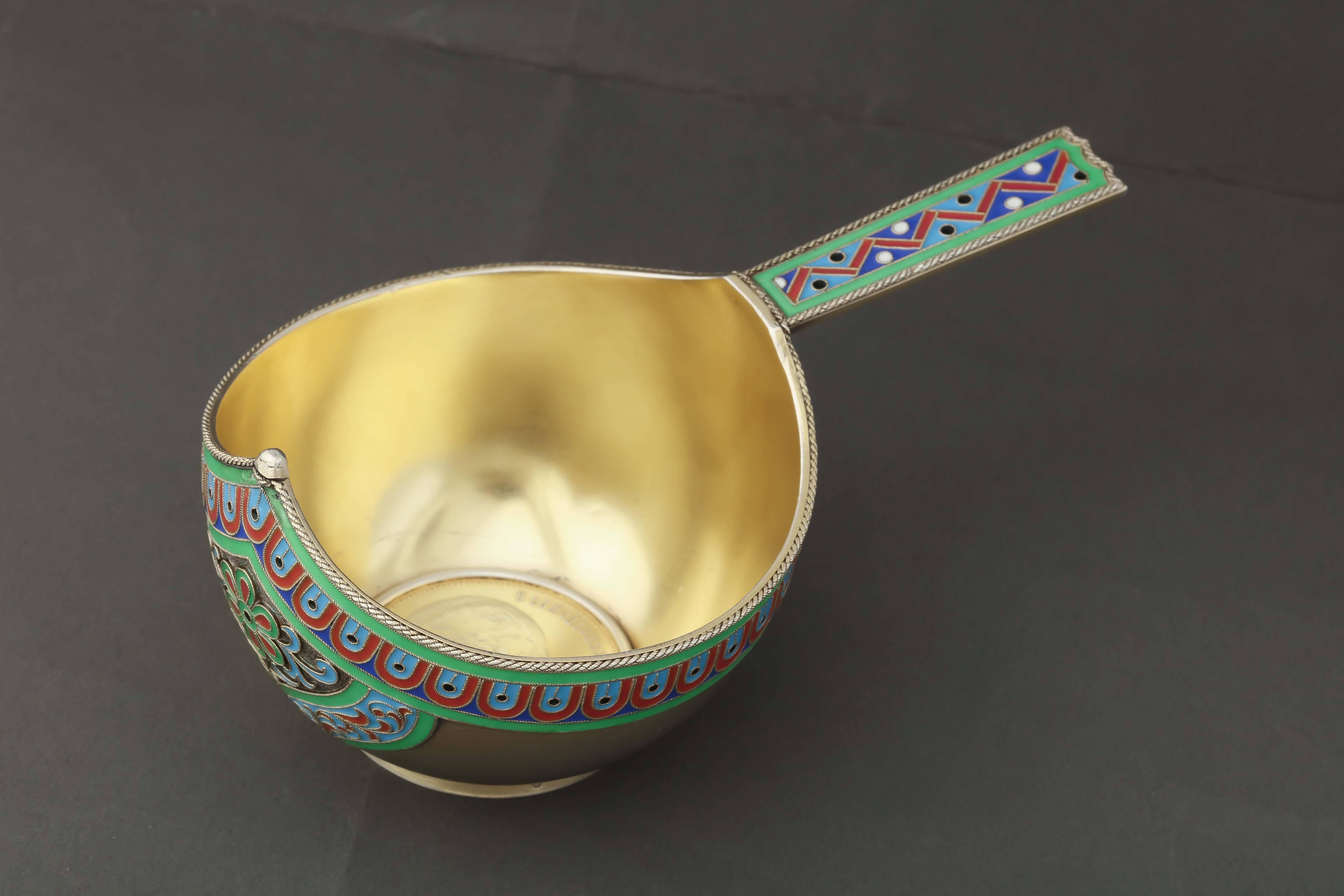 From the Romanov era period of Tsar Nicholas II, a beautiful gilded silver kovsh or traditional Russian bowl, the exterior and handle decorated with vibrant enamel colors in distinctive Old Russian entrelac design unique to Grachev of St.